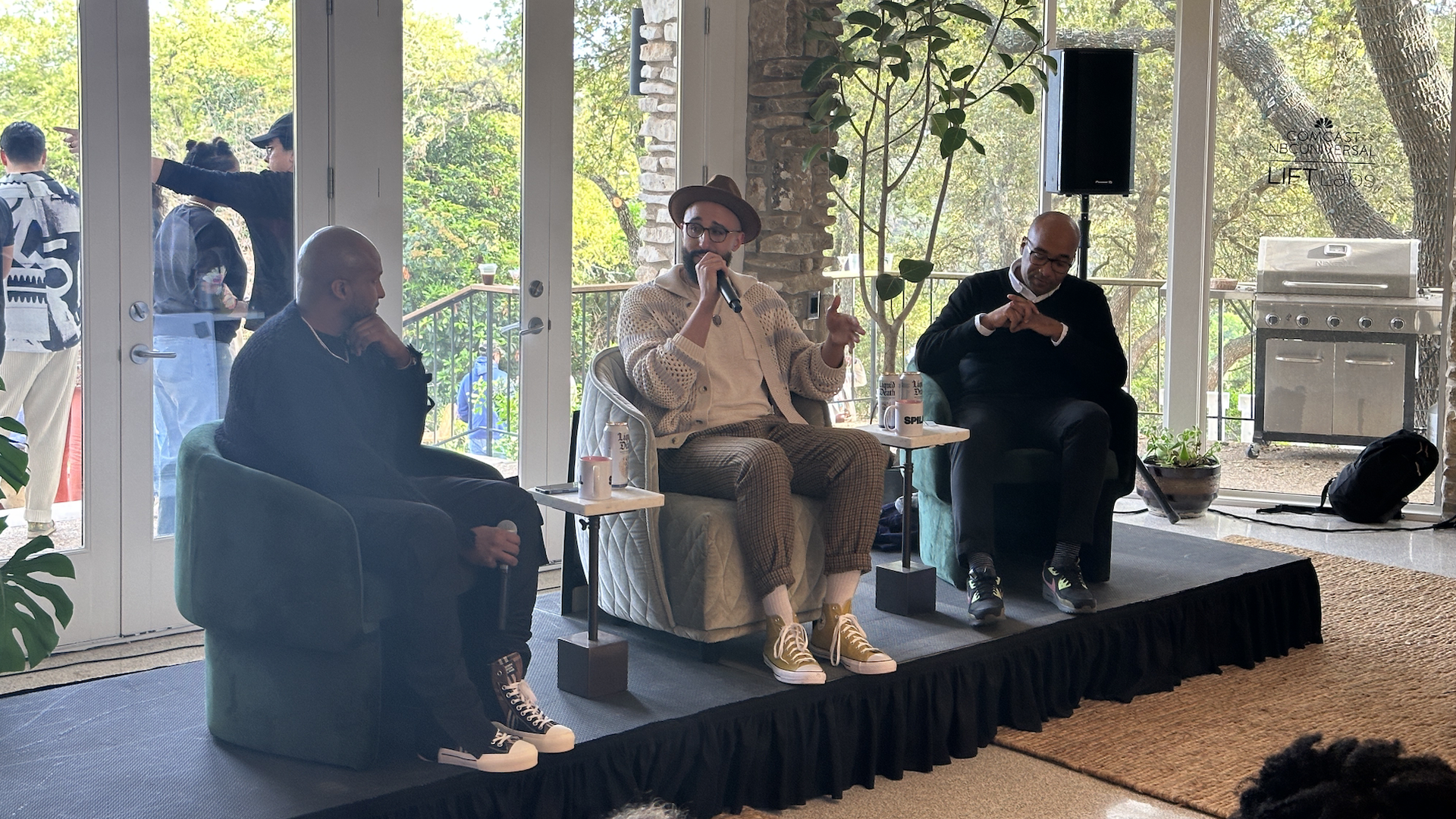 MAC Venture Capital's Marlon Nichols, Dr. Marcus Collins and Spill's Alphonzo Terrell sitting in chairs on a stage