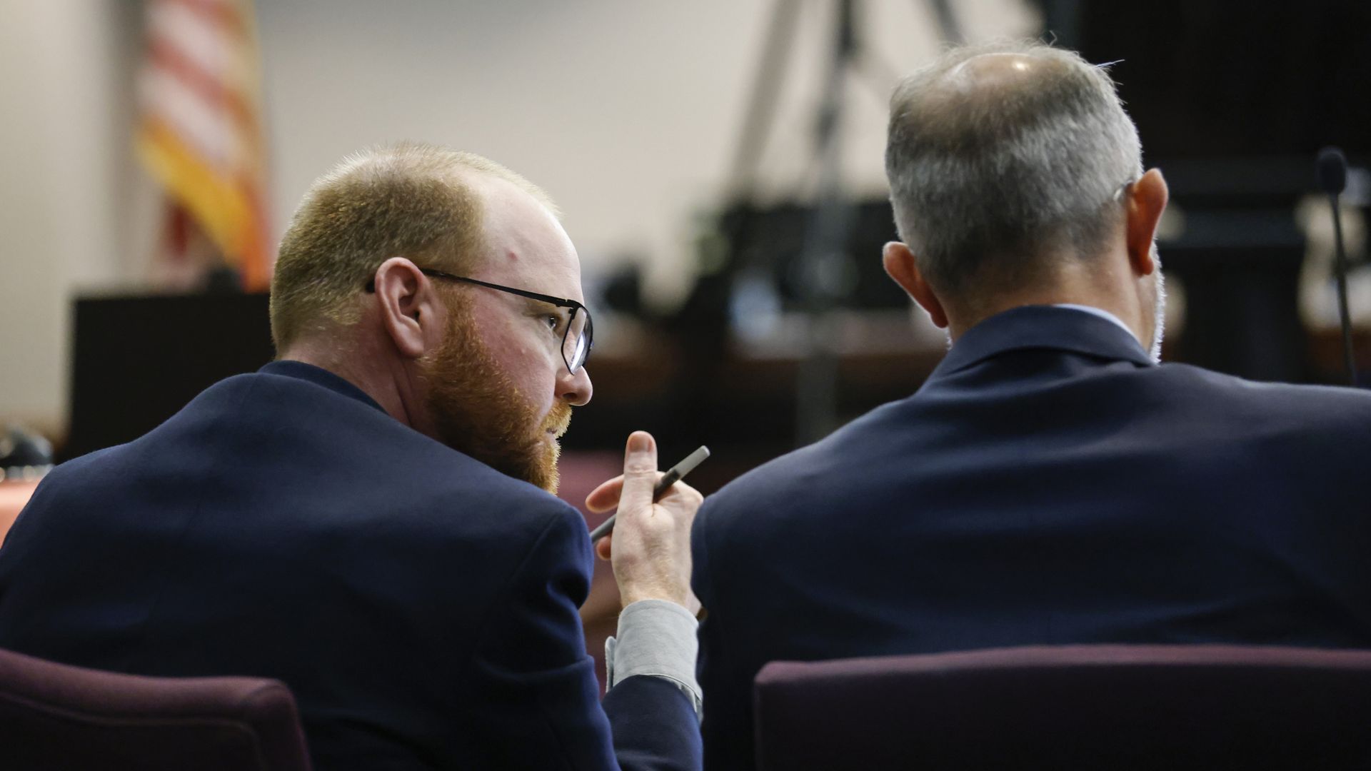 Travis McMichael, accused killer of Ahmaud Arbery speaks to his lawyer in the courtroom