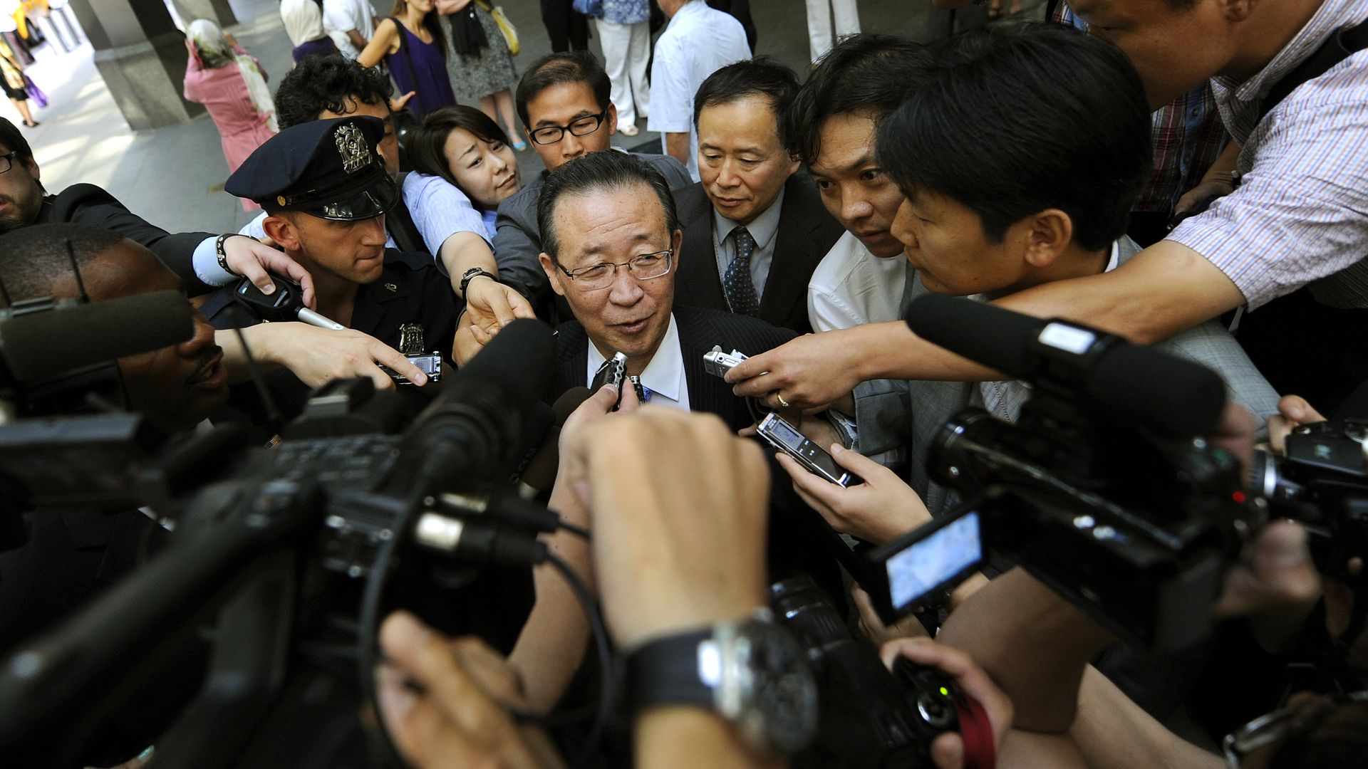 North Korean Vice Foreign Minister Kim Kye Gwan surrounded by media.