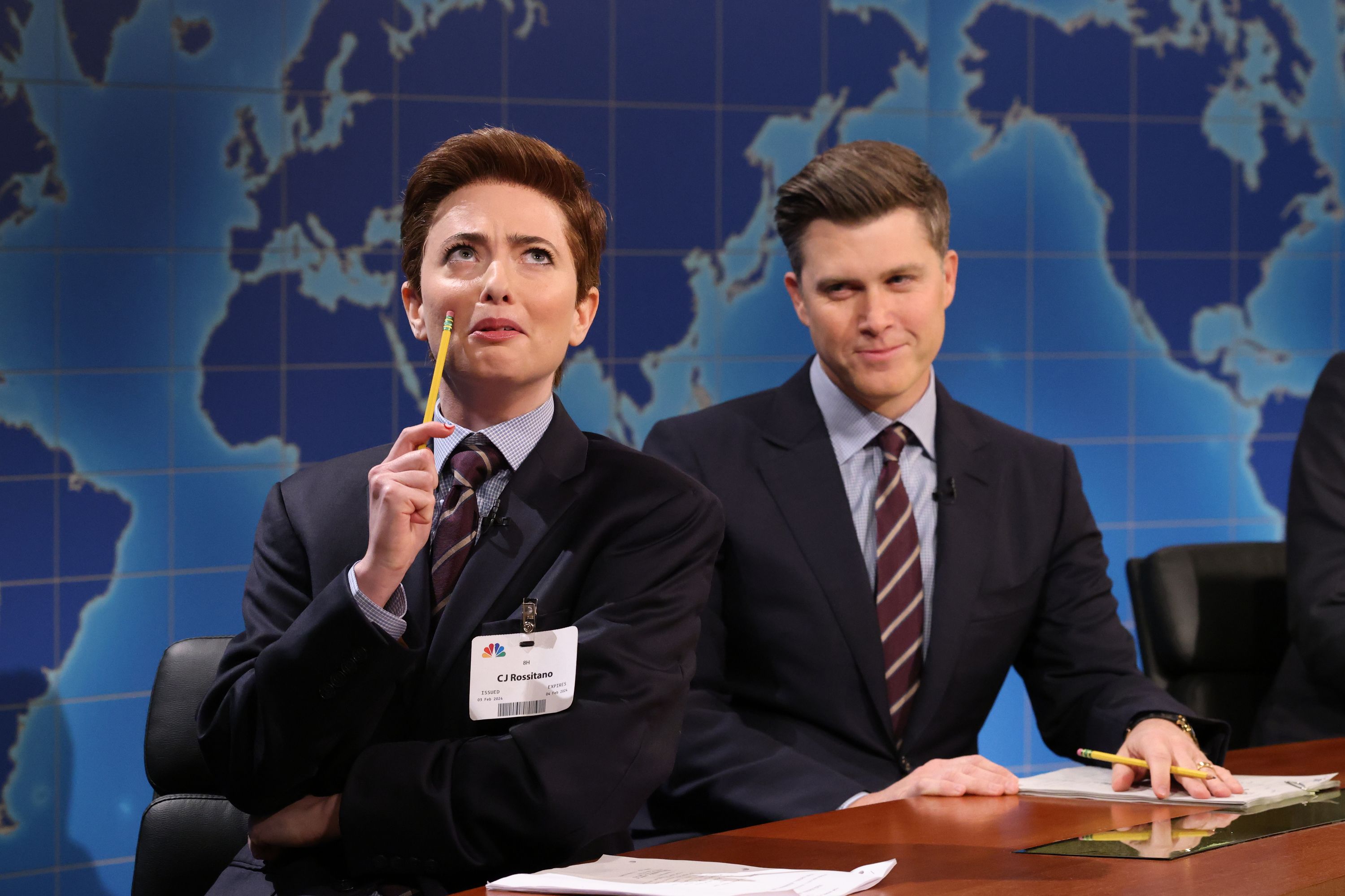 Photo of two people in suits doing a comedic sketch on television. 