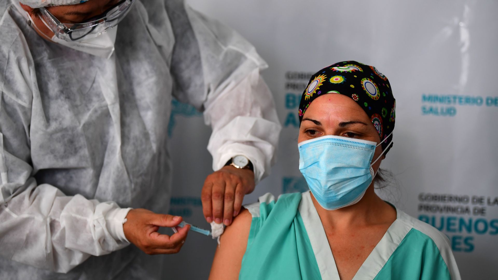 Picture of a health worker in Argentina receiving the Russian coronavirus vaccine