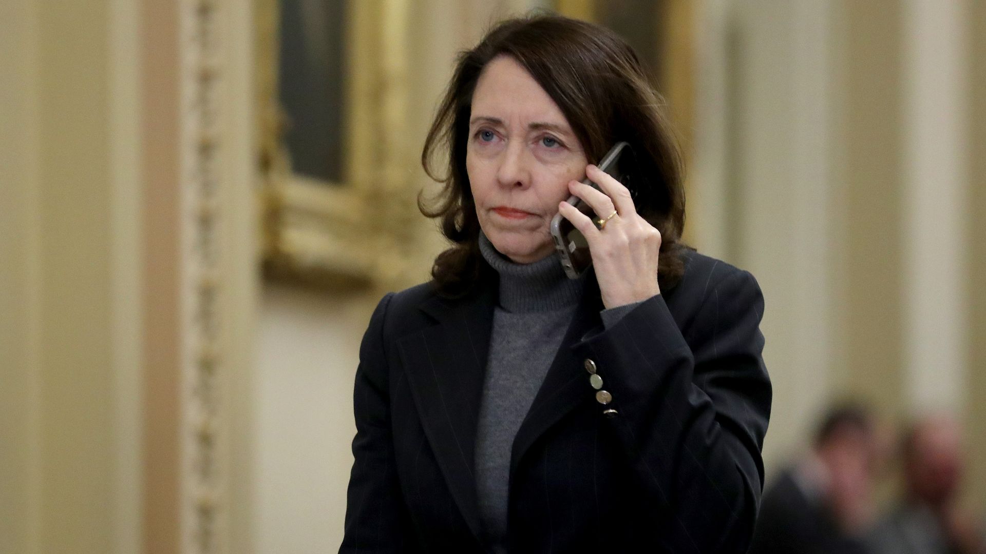 Sen. Maria Cantwell heads toward the Senate Chamber