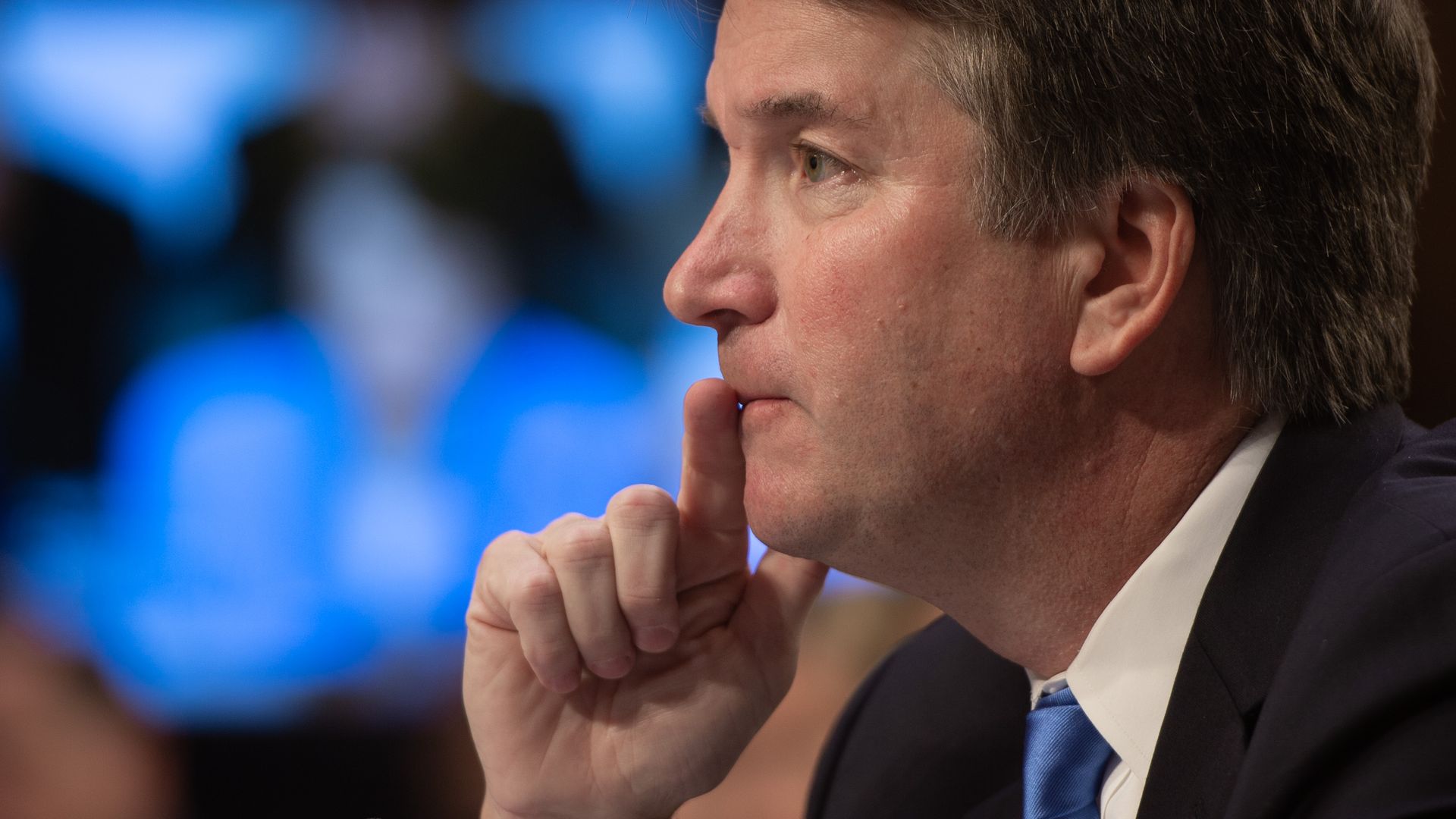 Brett Kavanaugh puts his hand on his fist while testifying