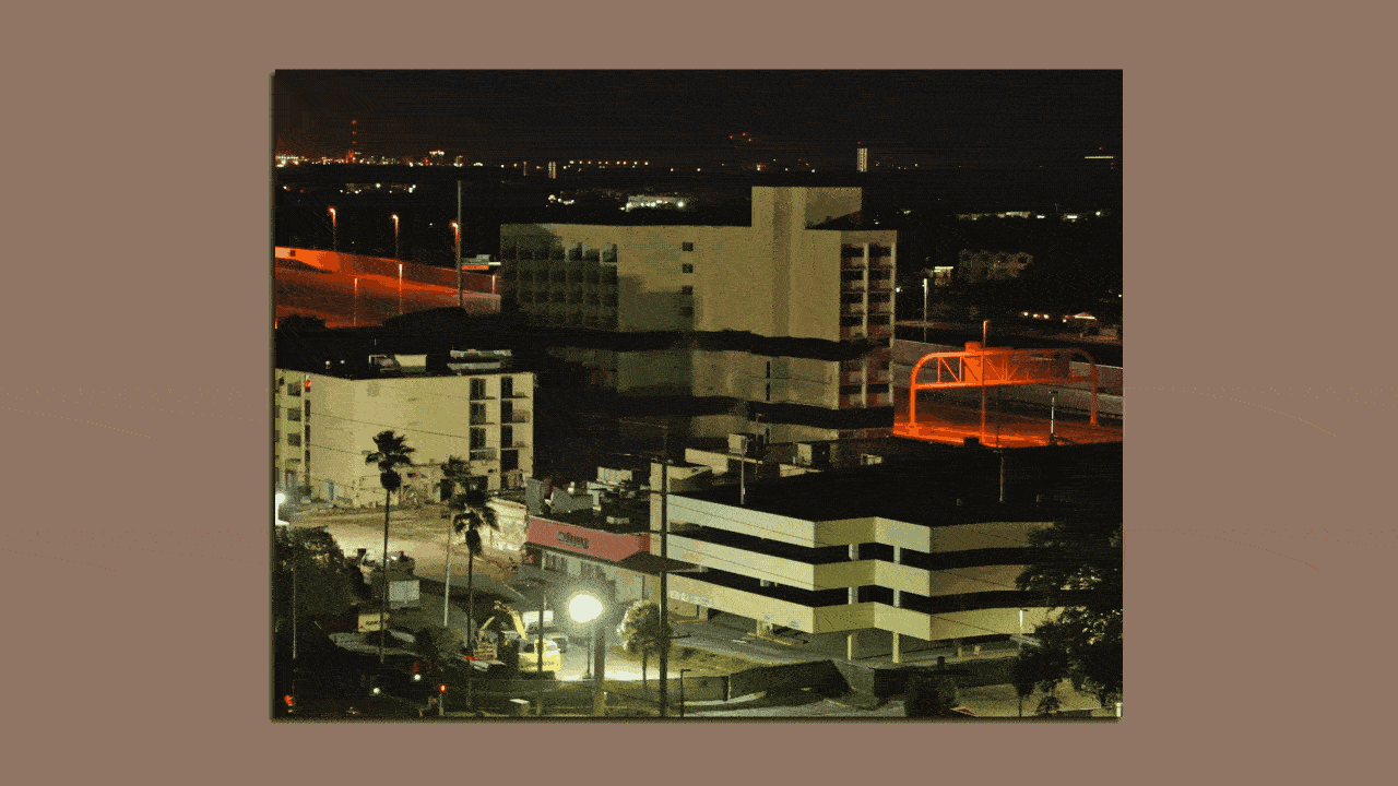 An animated image of a hotel building going down in smoke.