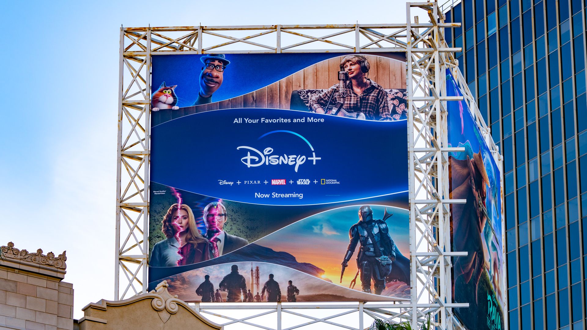 Photo of a Disney+ billboard with various characters from Disney films 