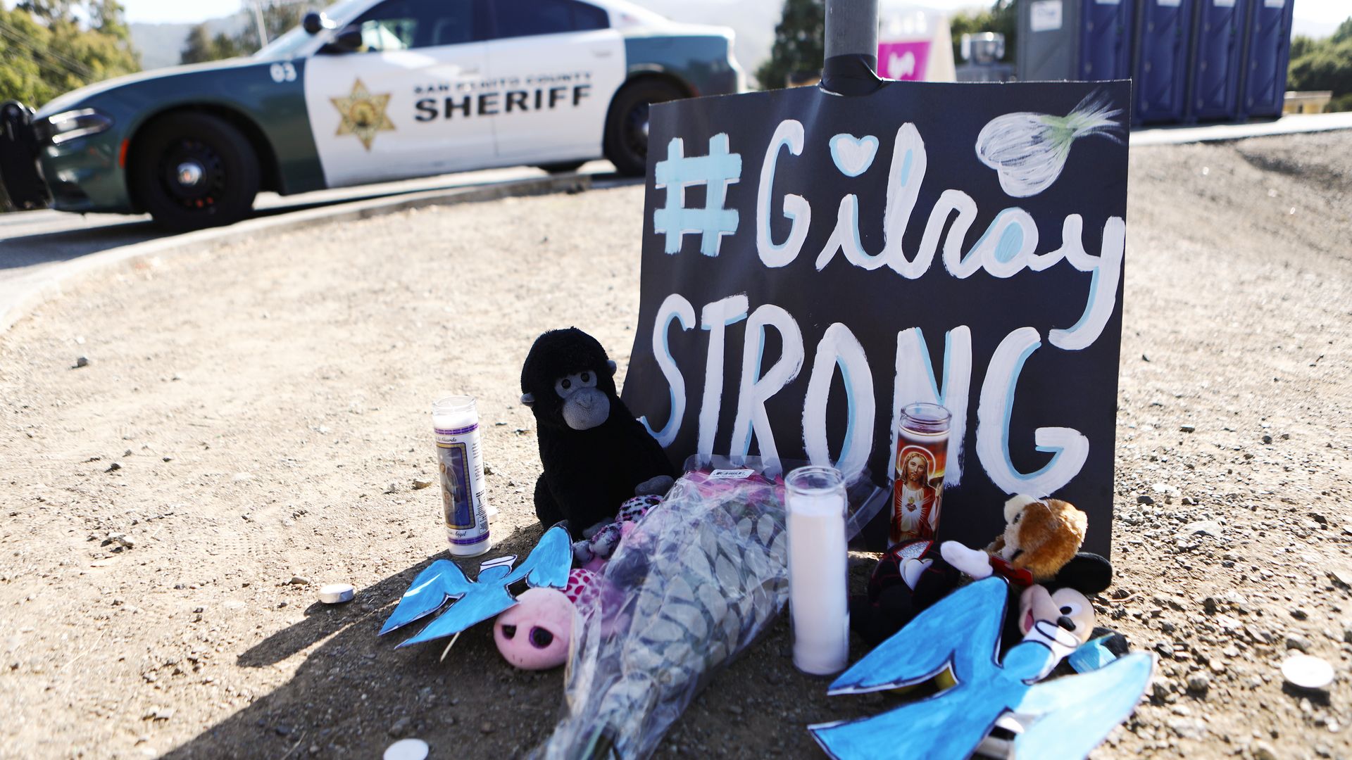 This image shows a memorial poster with the words Gilroy Strong in front of a hashtag.