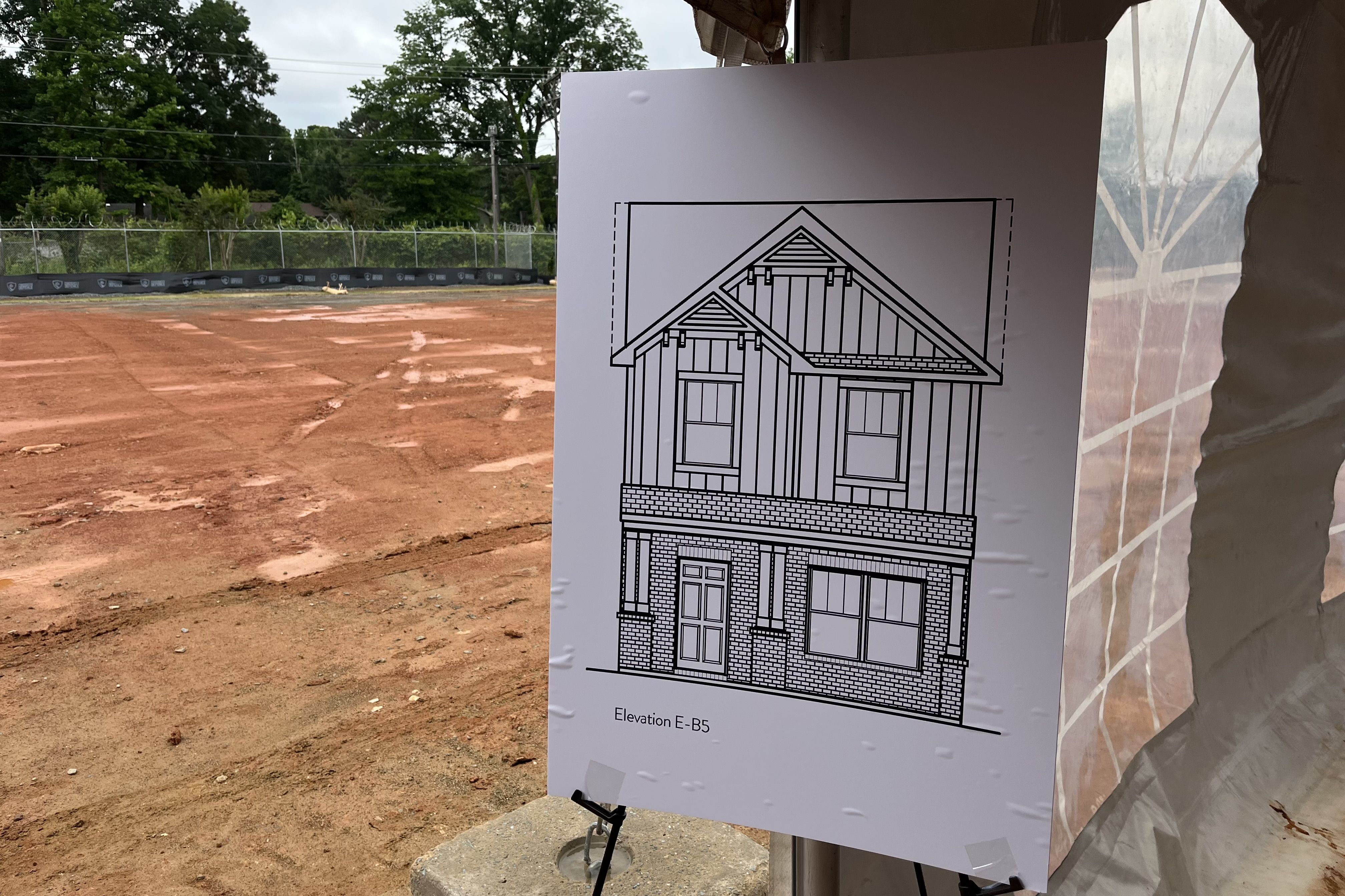 A sketch of a townhouse in front of a construction site