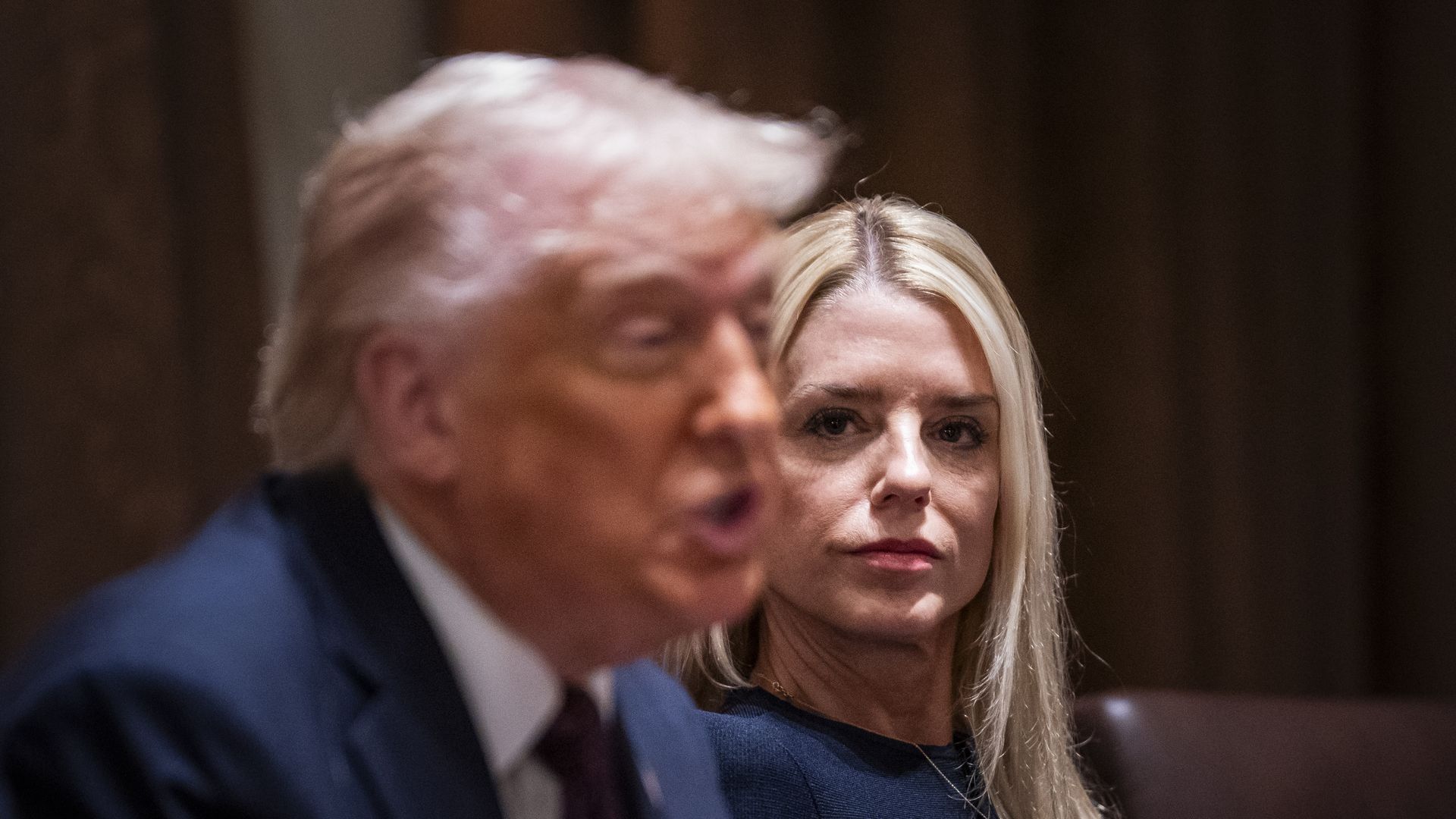Donald Trump speaking while Pam Bondi watches