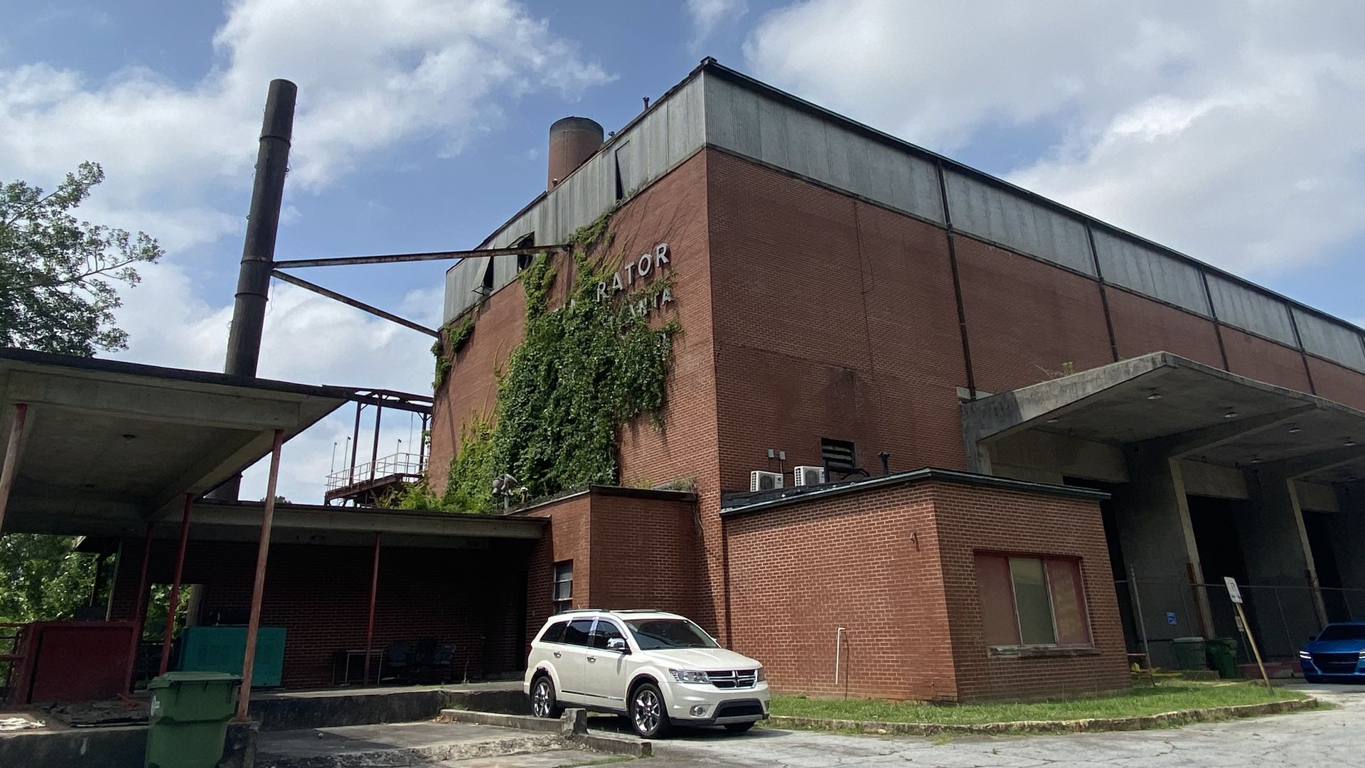 A photo of a large brick solid waste incinerator with a smokestack