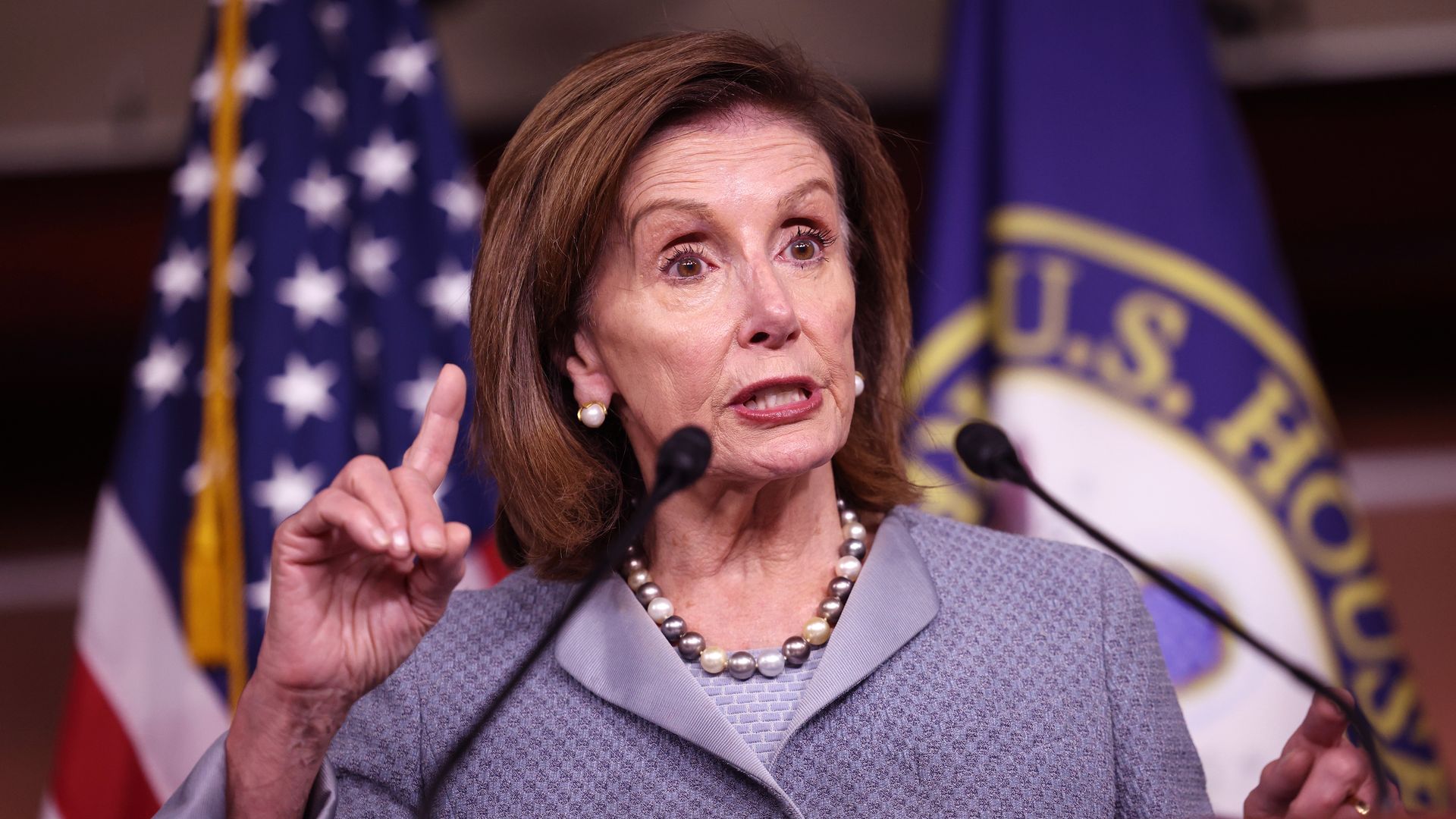 Pelosi speaks behind lectern