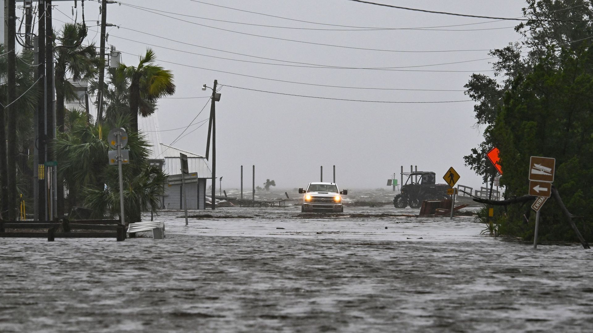 A truck driving on a flooded street during Hurricane Idalia in Florida.
