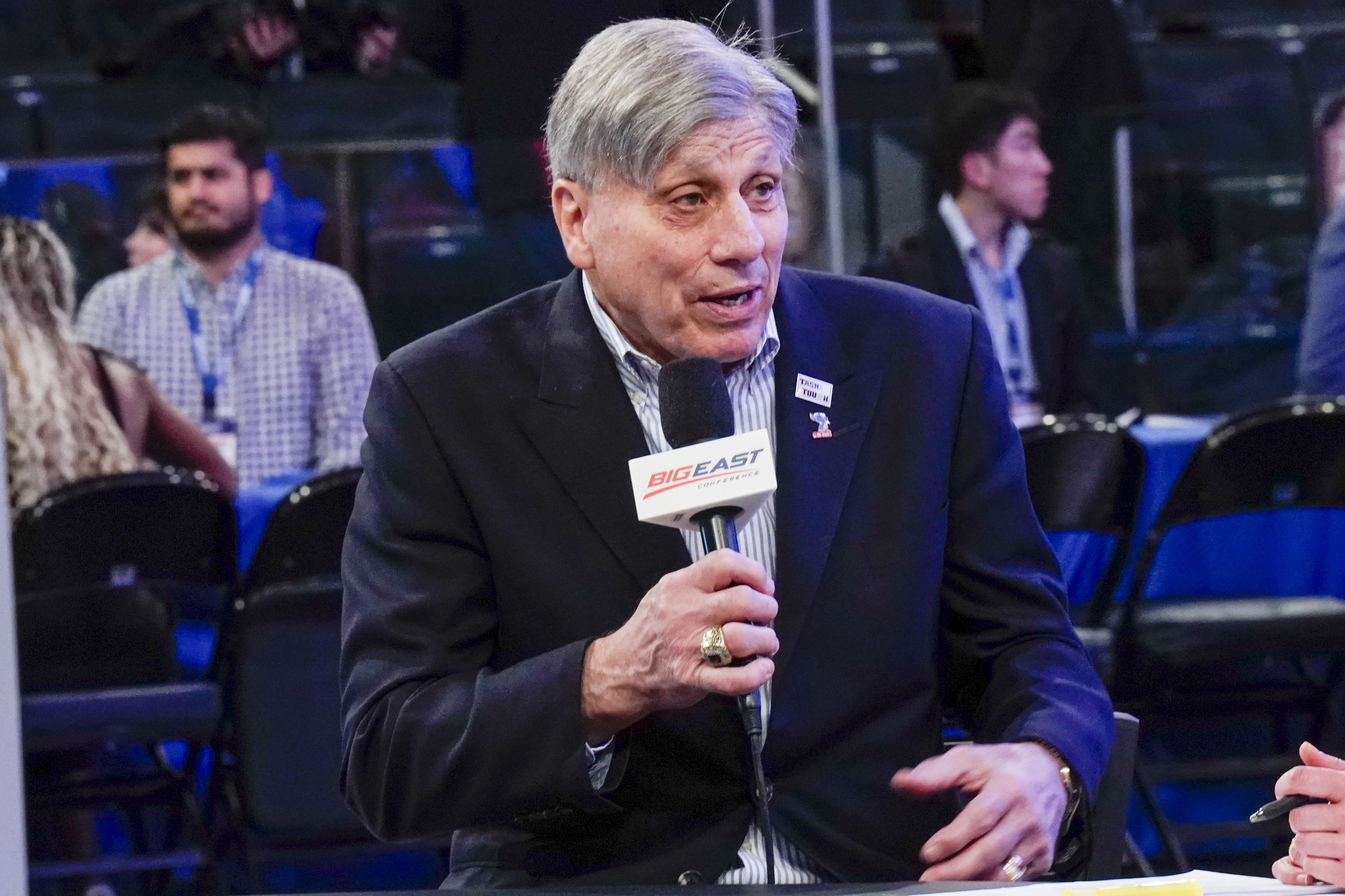 Photo of a man speaking into a microphone