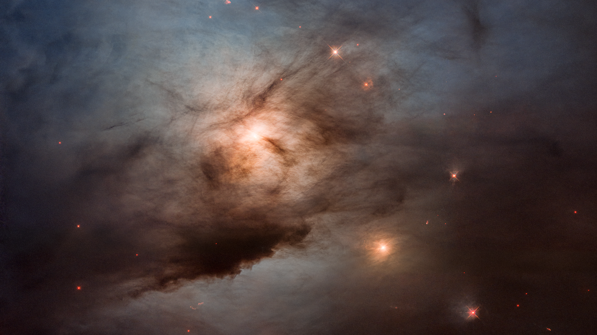 A whispey cloud of dust surrounds a yellow star as seen by the Hubble Space Telescope
