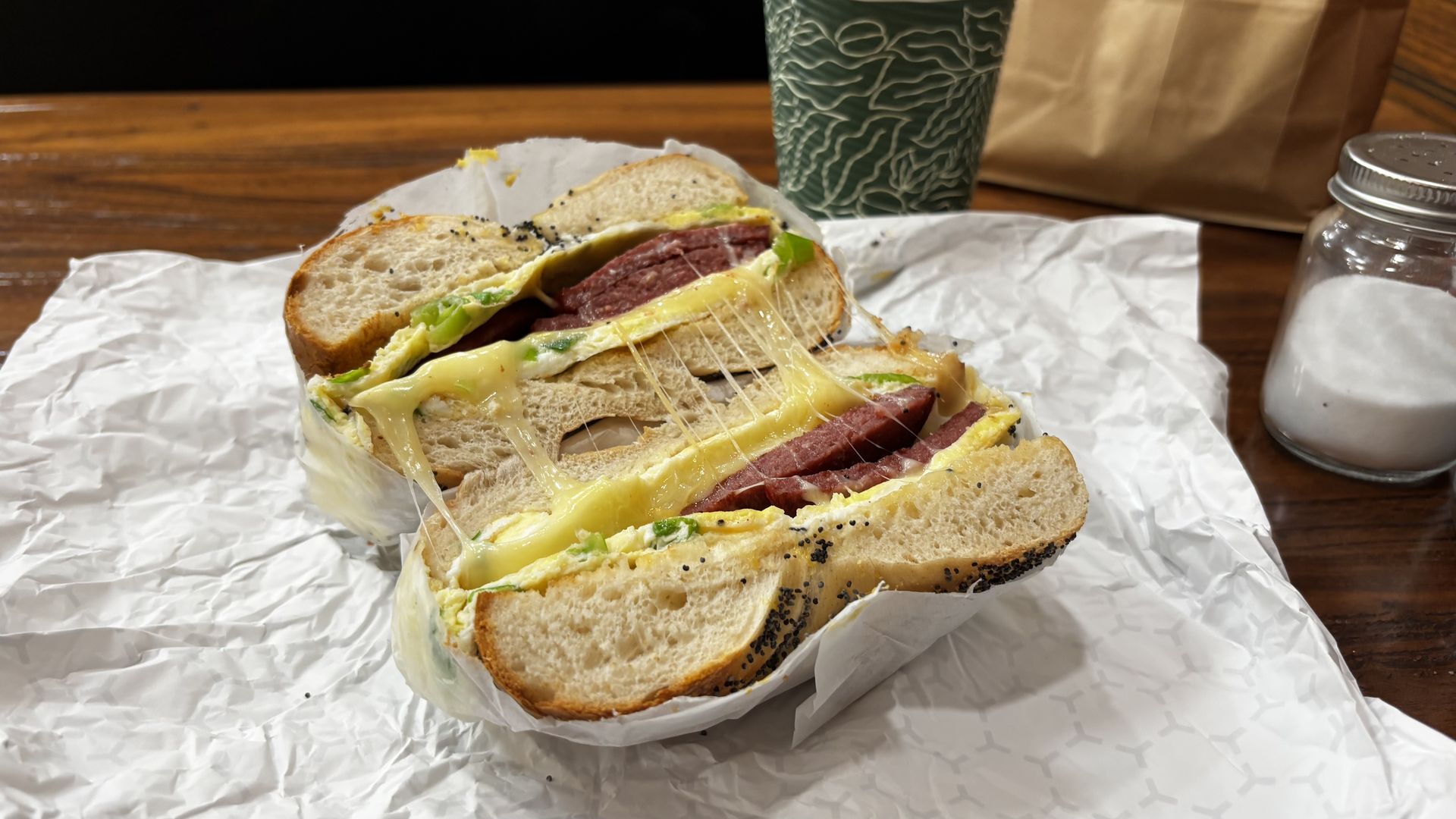 Close-up of a half cut bagel sandwich, known as the "Italian Scallion" at the Bagel Spot.