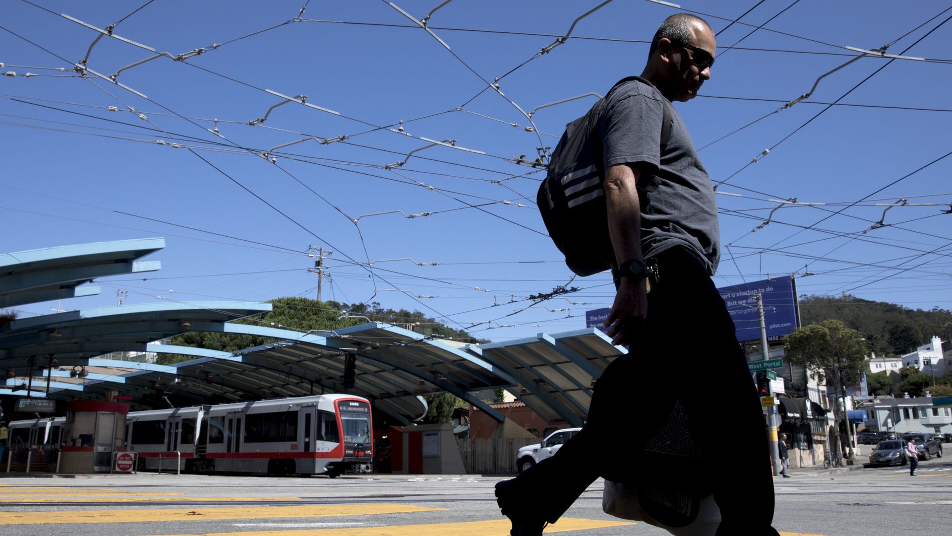 person walks under overhead wires