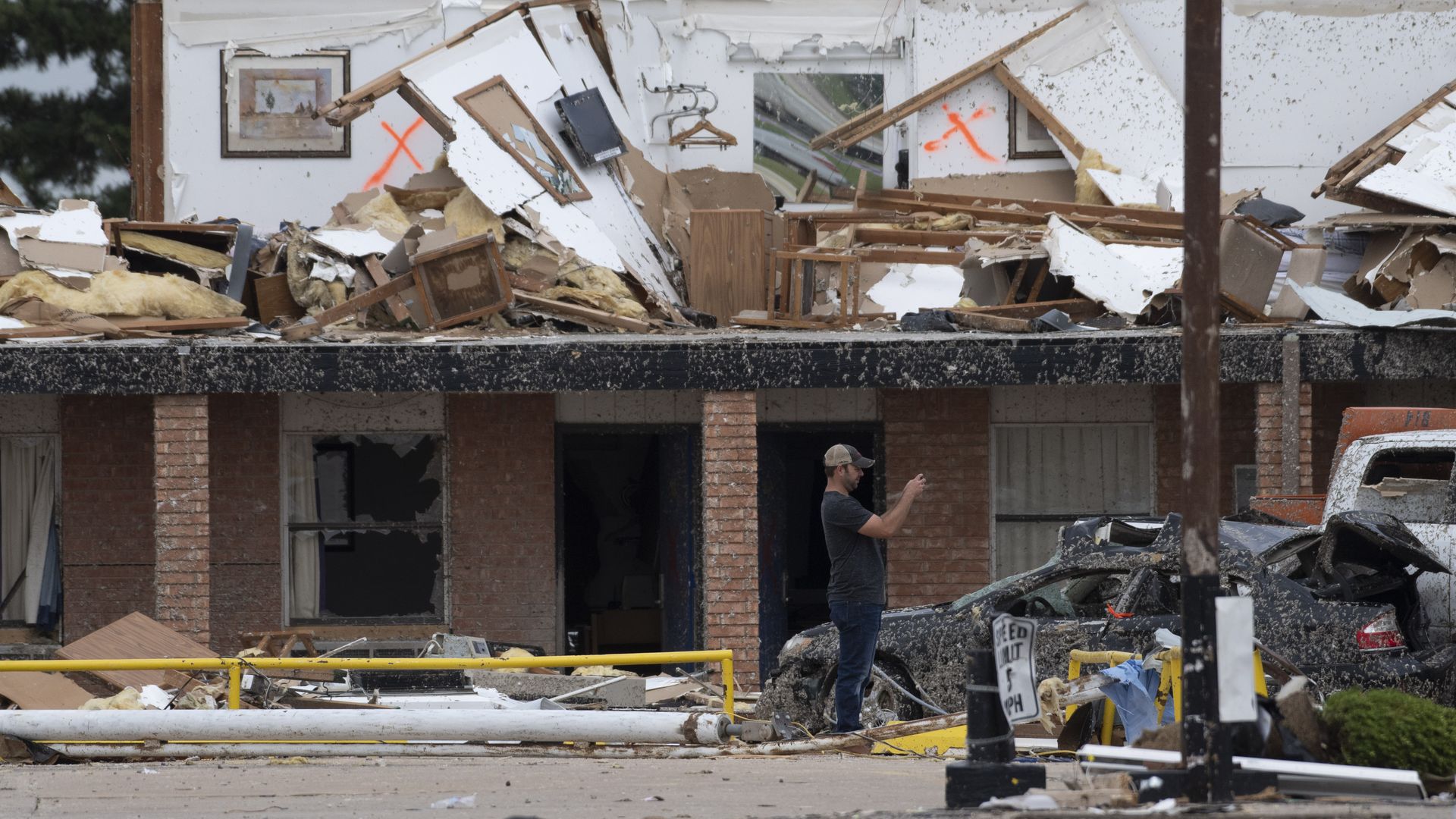 A rescue worker takes photos of the American Value Budget Inn May 26, 2019 in El Reno, Oklahoma. 