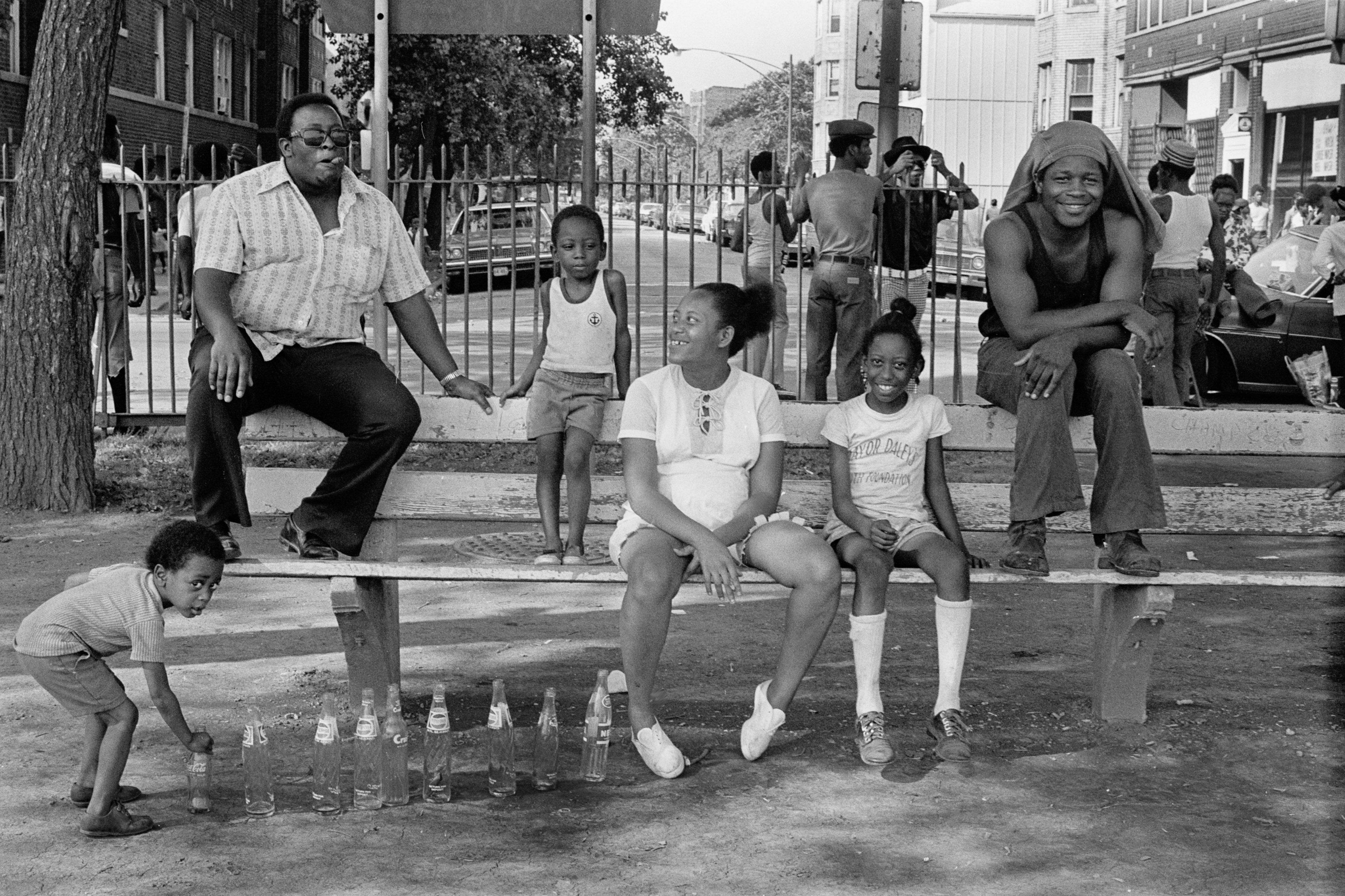 Photo of people sitting on a park bench 