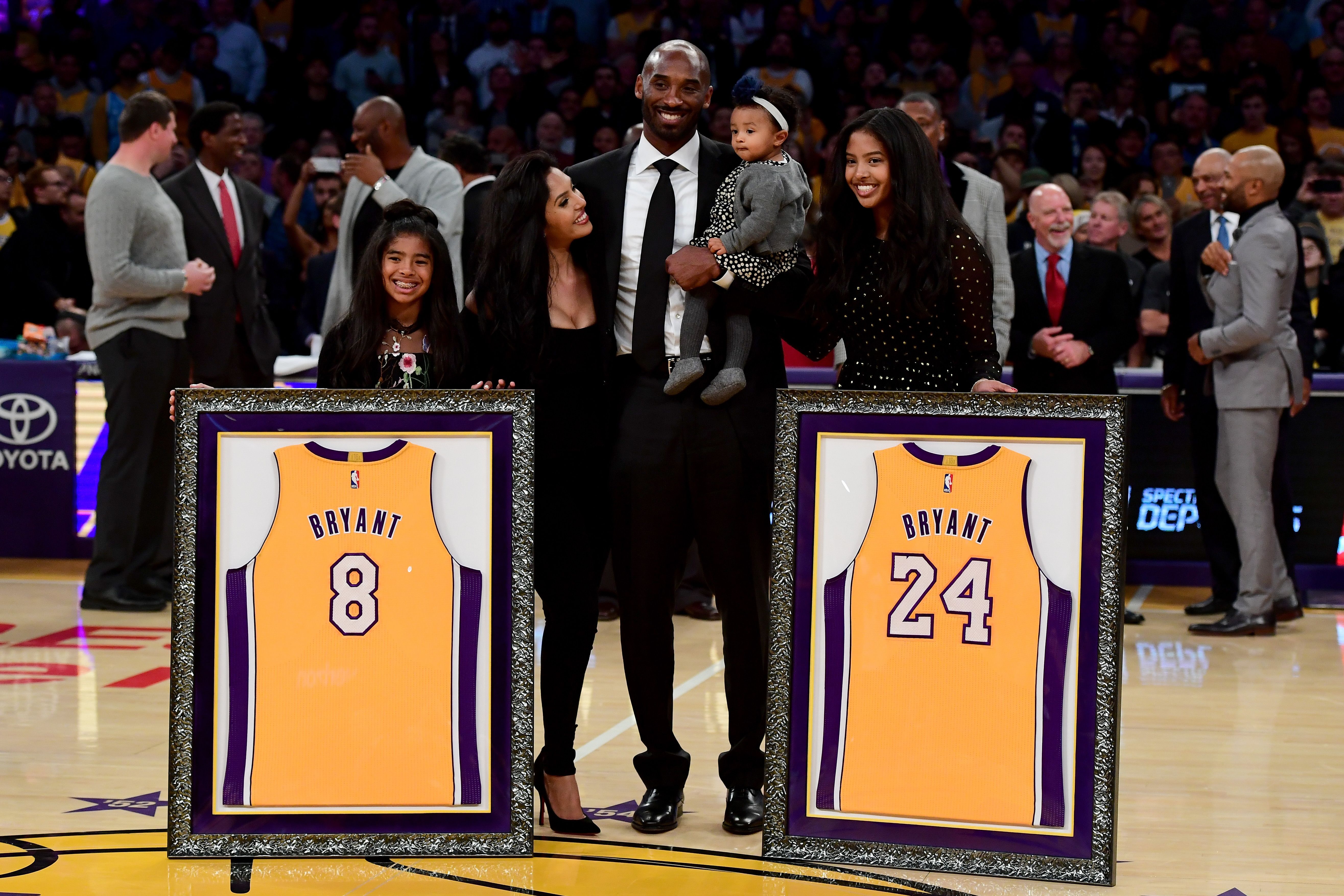 Kobe Bryant poses with his family at halftime after both his #8 and #24 Los Angeles Lakers jerseys are retired at Staples Center on December 18, 2017 in Los Angeles