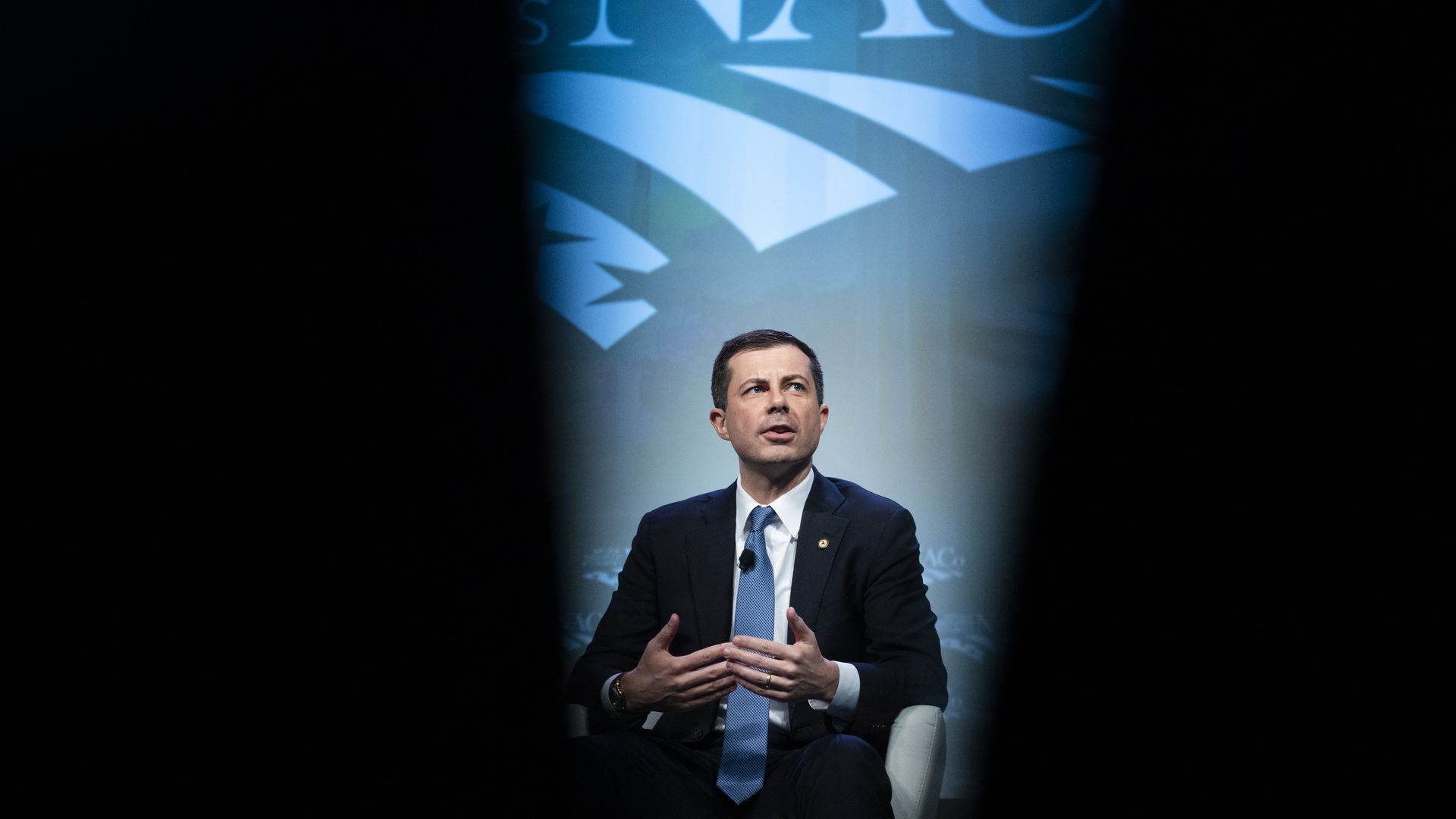 Transportation Secretary Pete Buttigieg, wearing a dark blue suit, white shirt and blue tie.