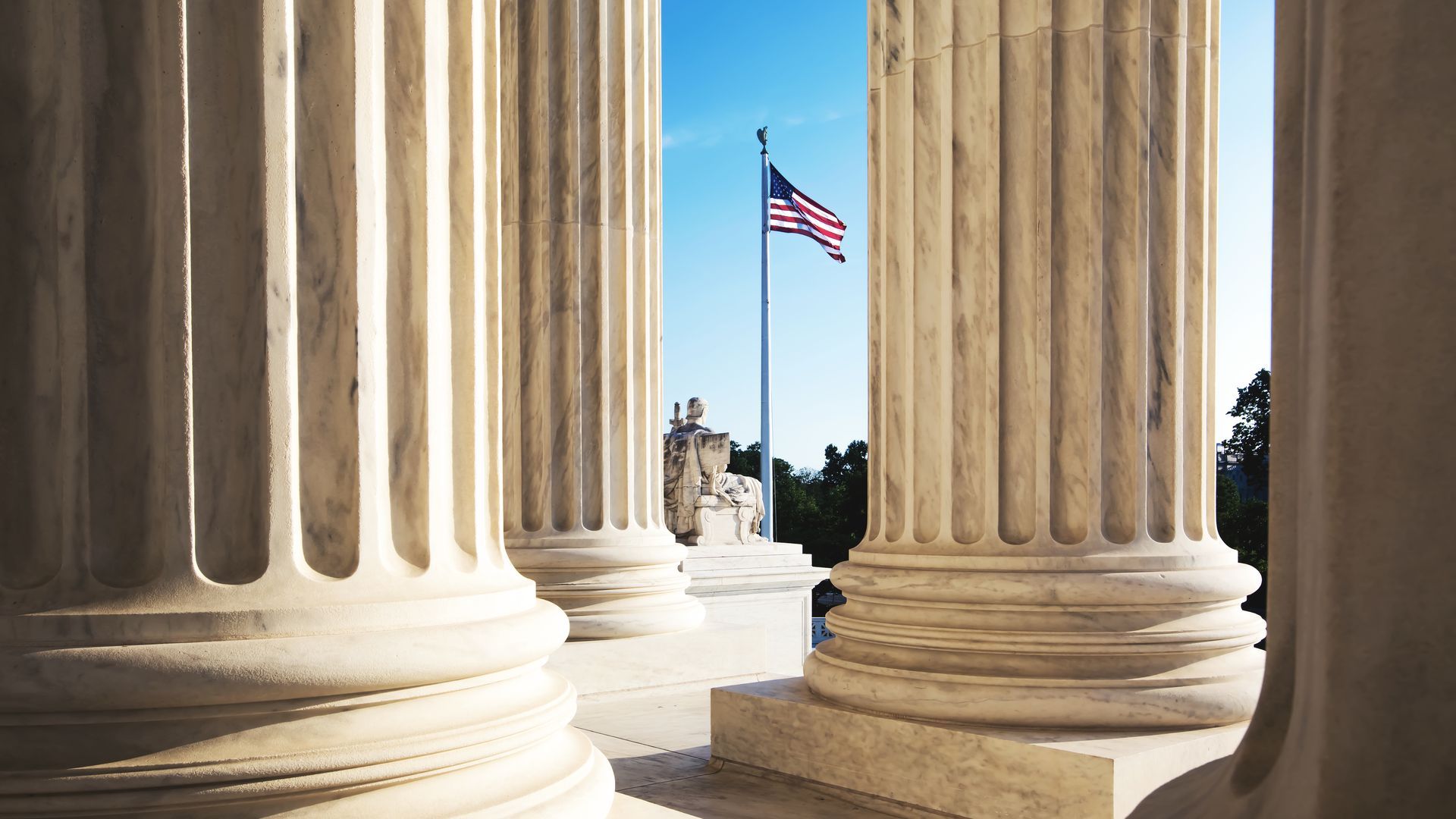 American flag behind pillars