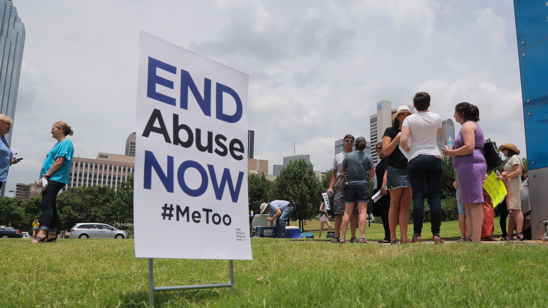 A picture of a sign that says "End Abuse NOW!"