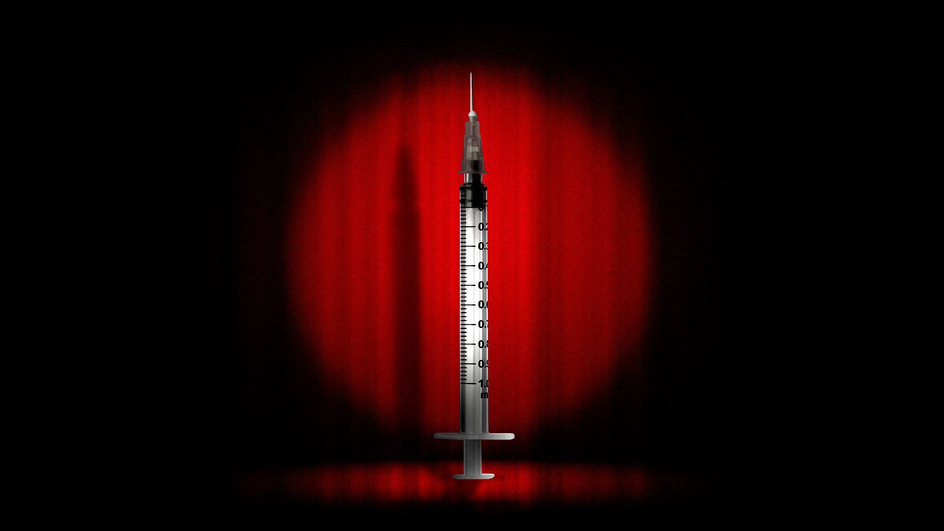 A syringe in the spotlight in front of a red show curtain