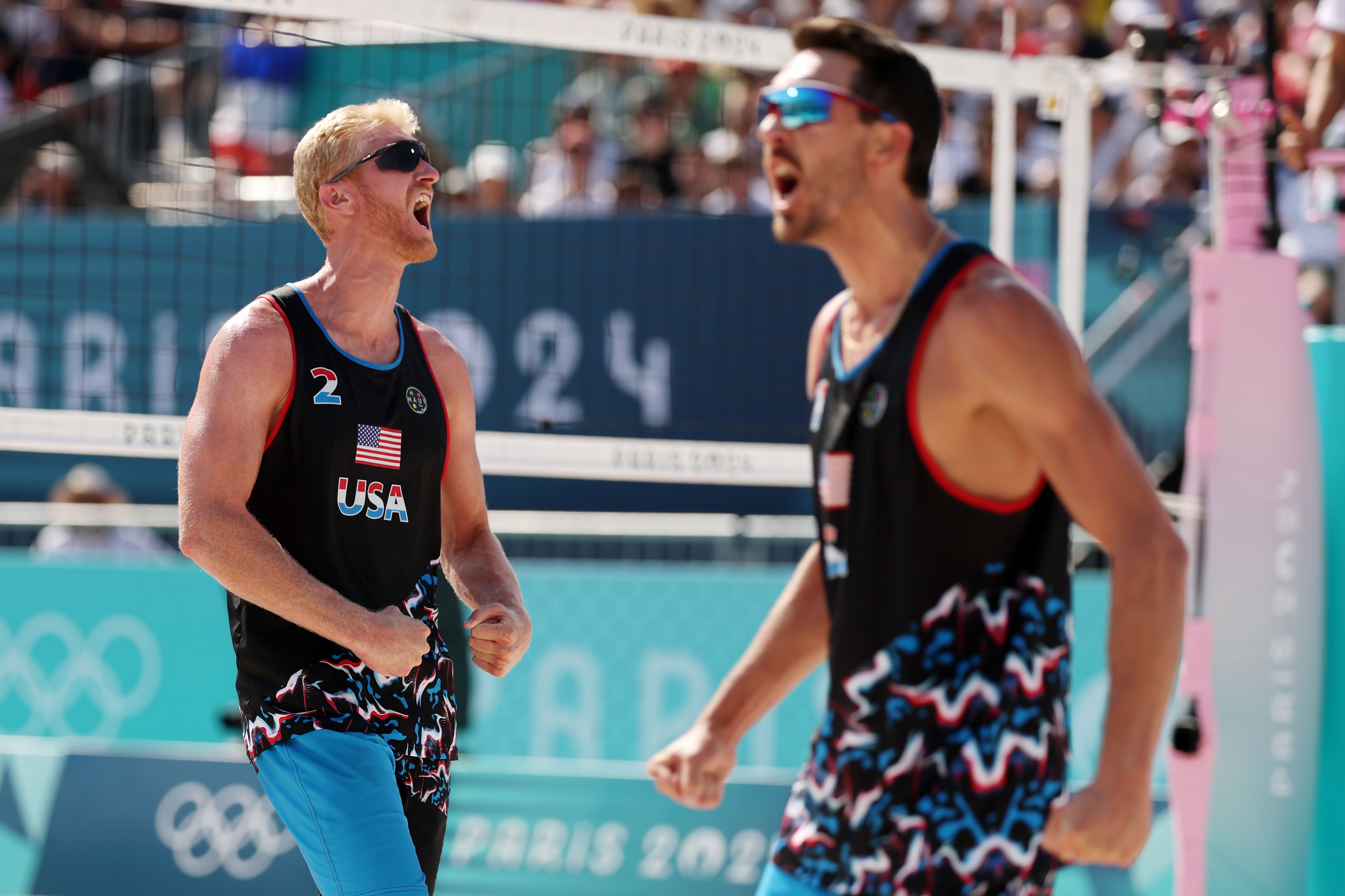 Chase Budinger and partner Miles Evans celebrate on the court.