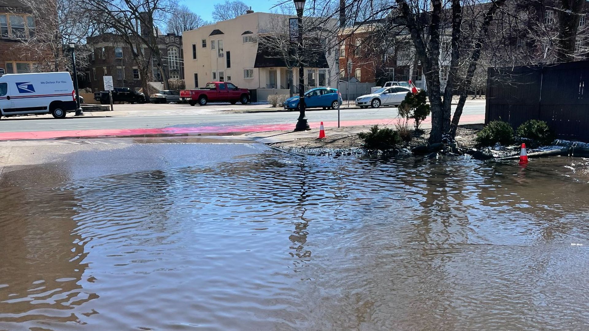 A large puddle in a parking lot.