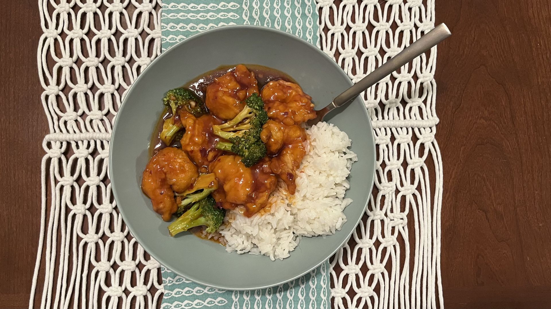 Shrimp, broccoli and rice in a blue bowl on a table