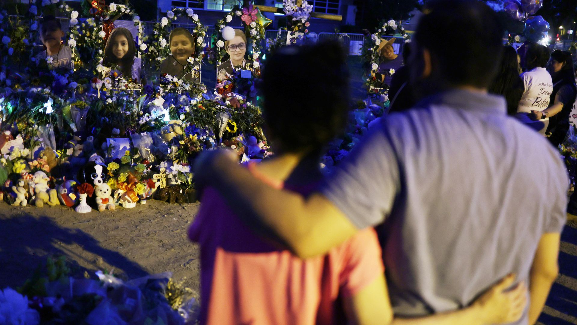 People looking at a memorial outside Robb Elementary School June 2 in Uvalde, Texas.