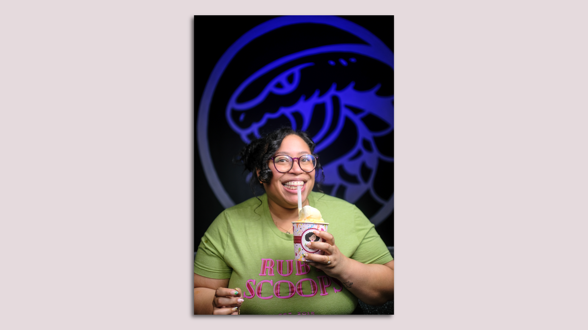 Rabia, the shop owner, is smiling and holding ice cream 