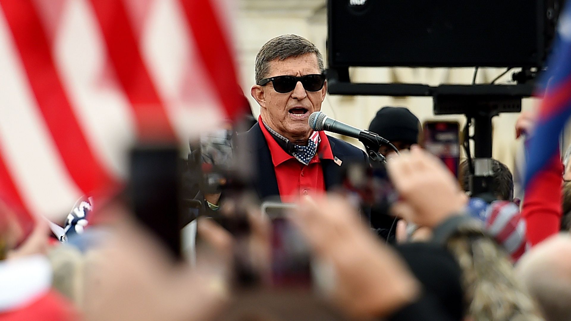 Michael Flynn wears sunglasses and stands in front of a crowd