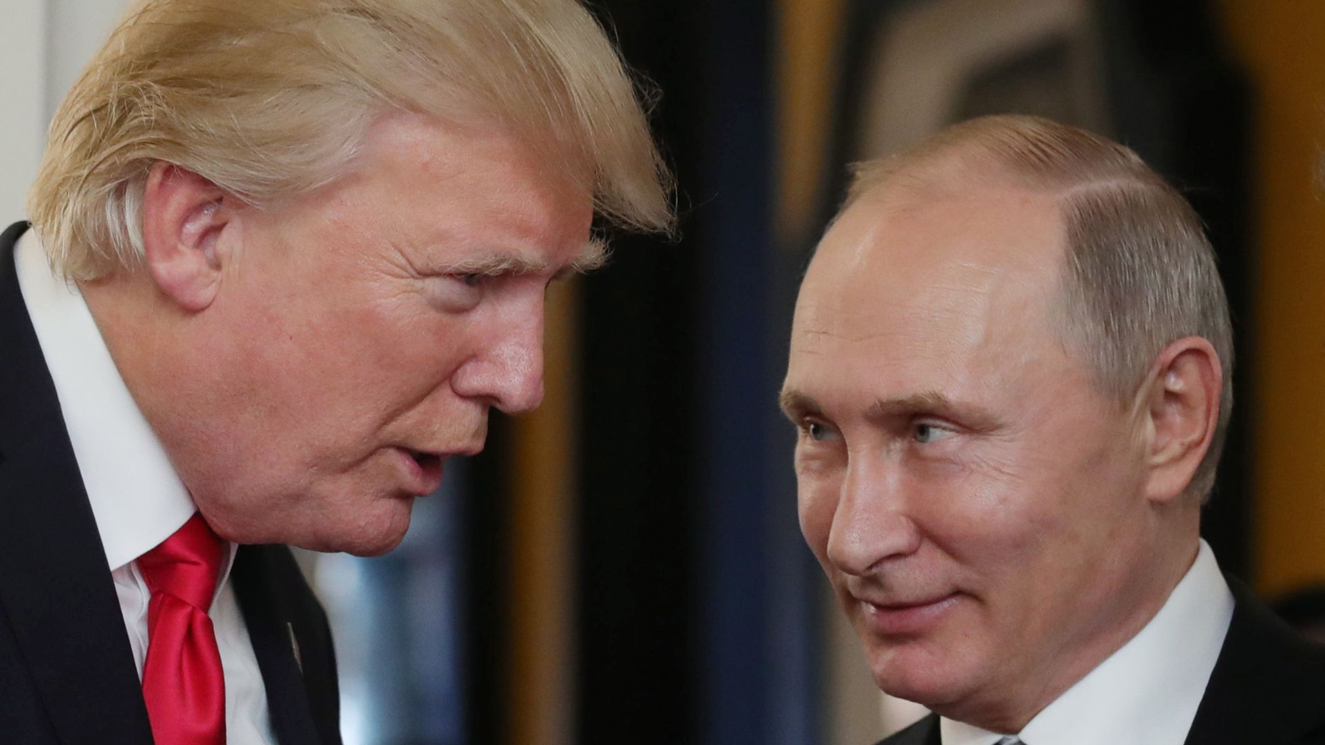 Trump and Putin facing each other in conversation