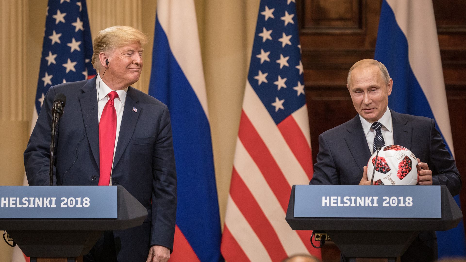 Trump smiles over at Putin, who's holding a soccer ball 