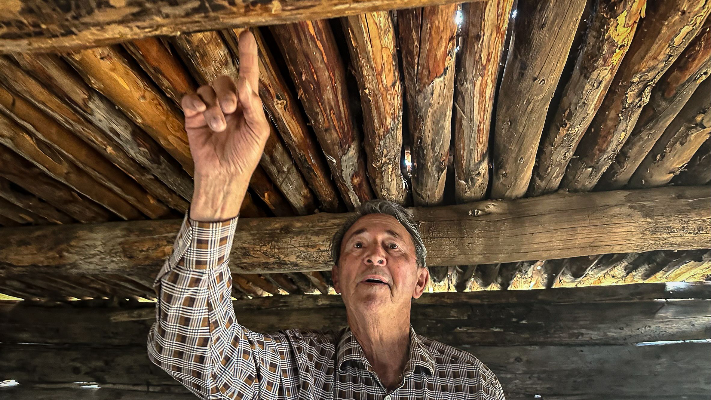 Moises Morales Jr., a rancher in Canjilon, New Mexico, shows the etchings his grandfather made in a cabin he built in the 1930s in the Carson National Forest.