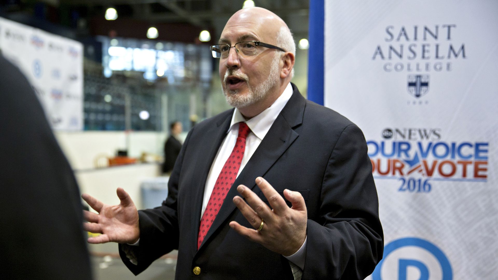 Democratic strategist Jeff Weaver is shown in a dark suit, white shirt and red tie.