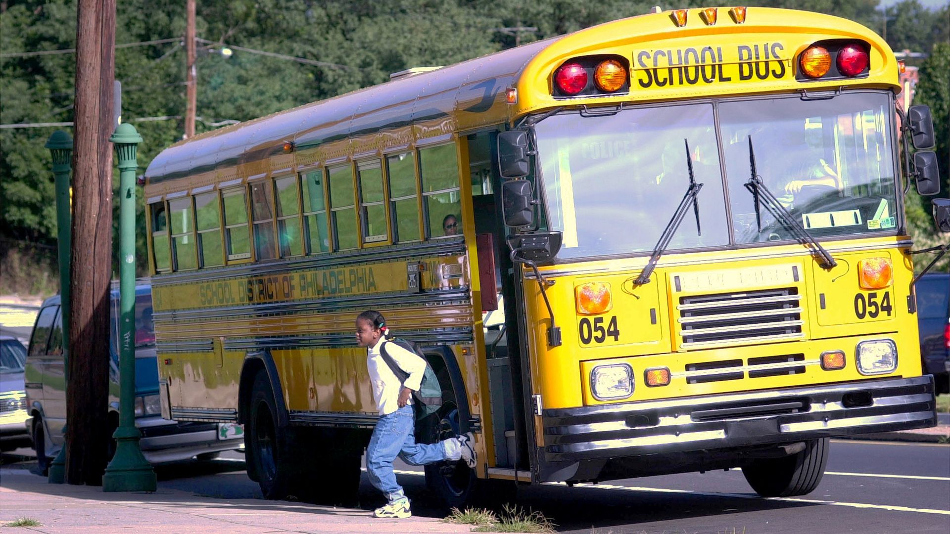 An unidentified student exits the bus on her way to school. Photo: William Thomas Cain/Getty 