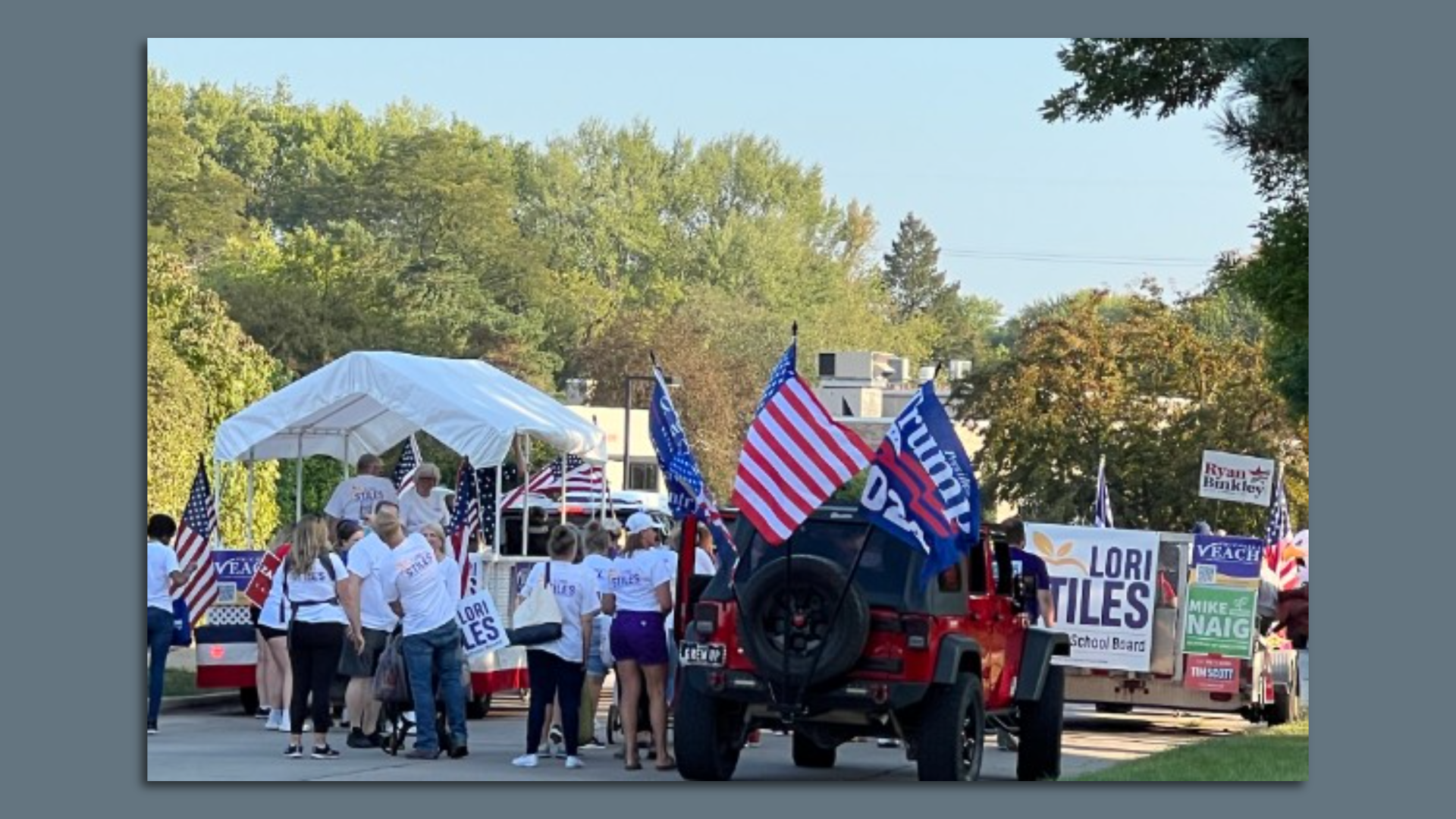 A jeep with Trump flags on it