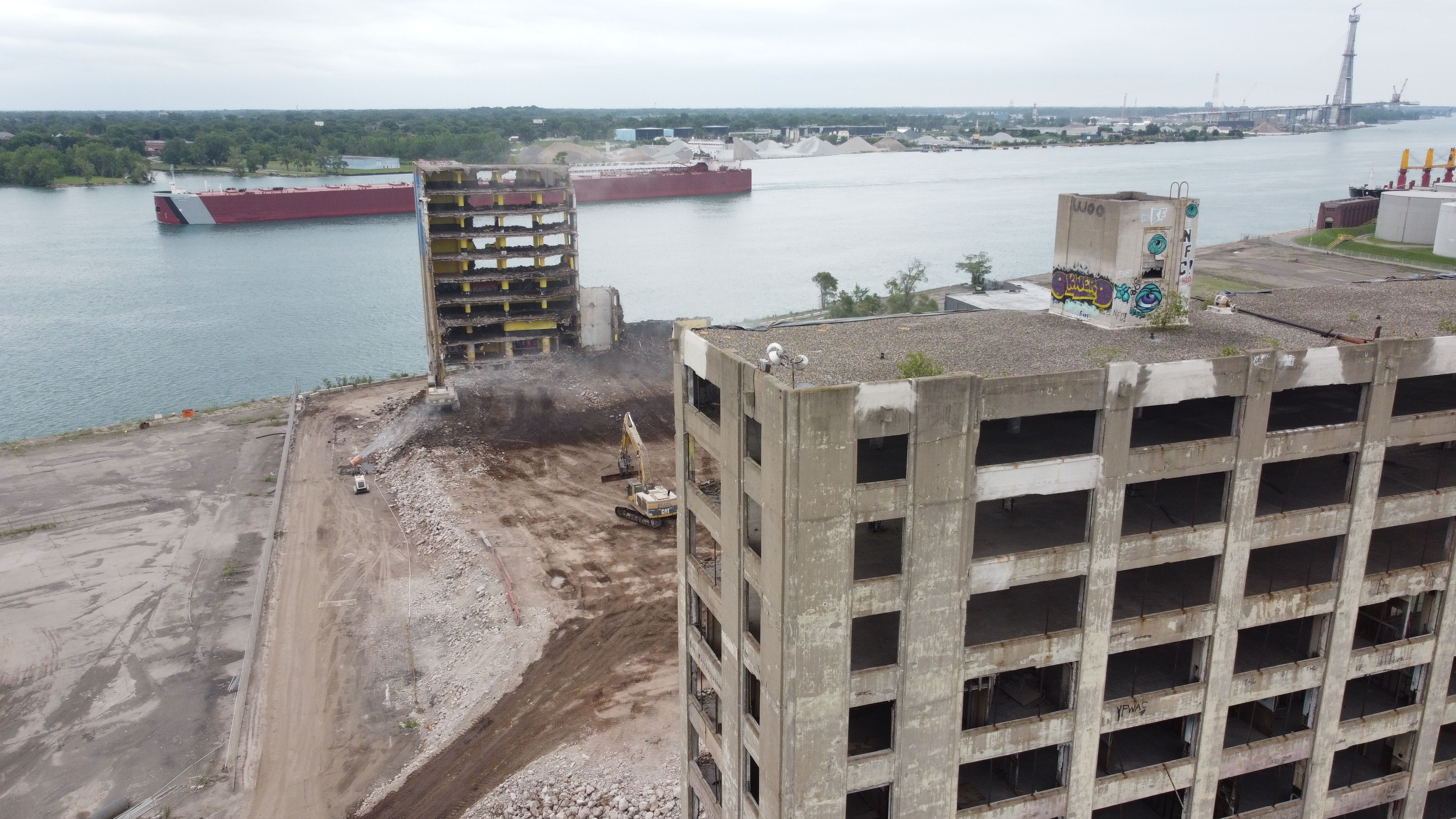 A view of the Boblo demolition site with a large barge in the Detroit River and Canada behind it 