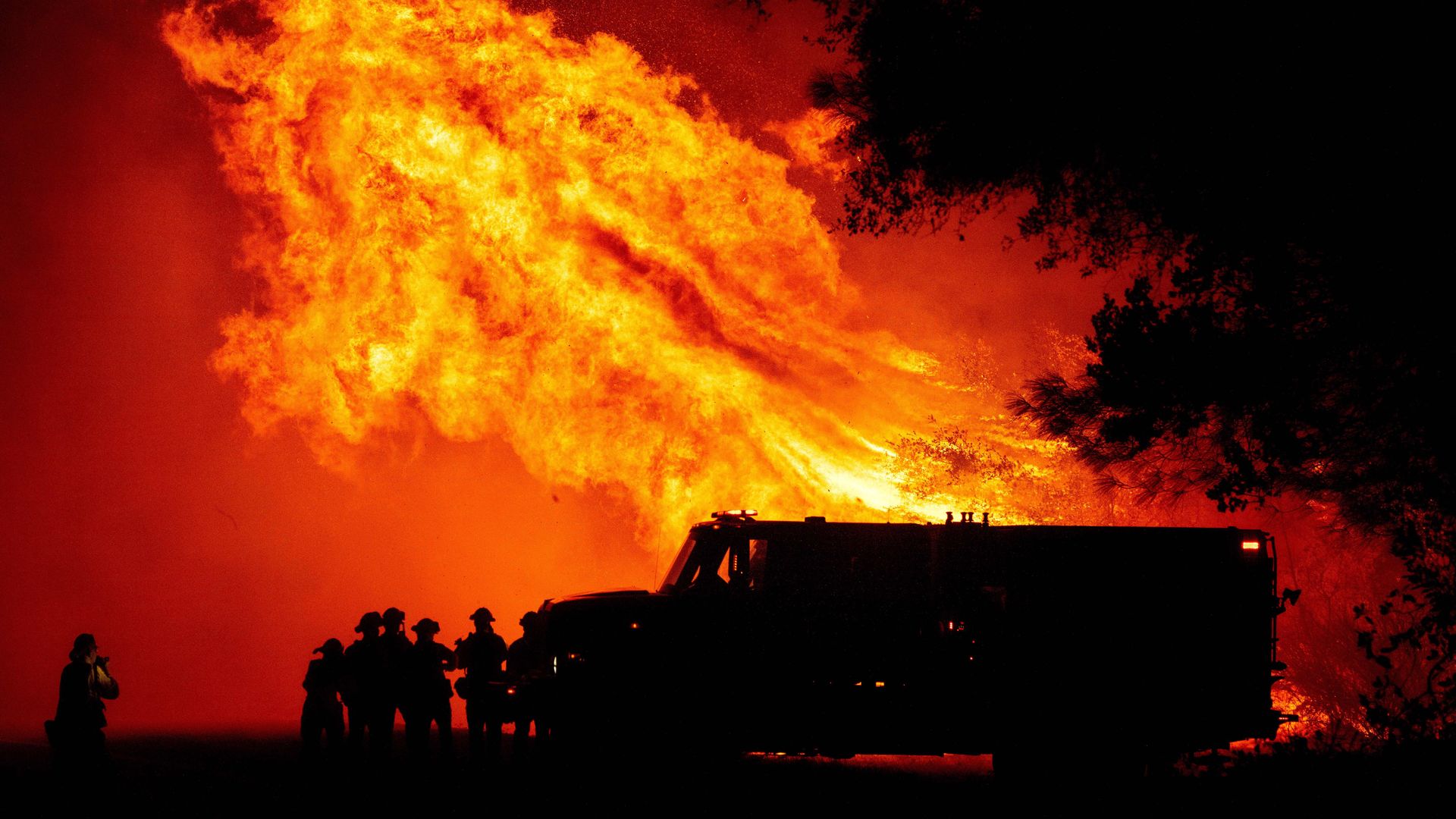Firefighters in Butte County, California, watch a tower of flame on Sept. 9.