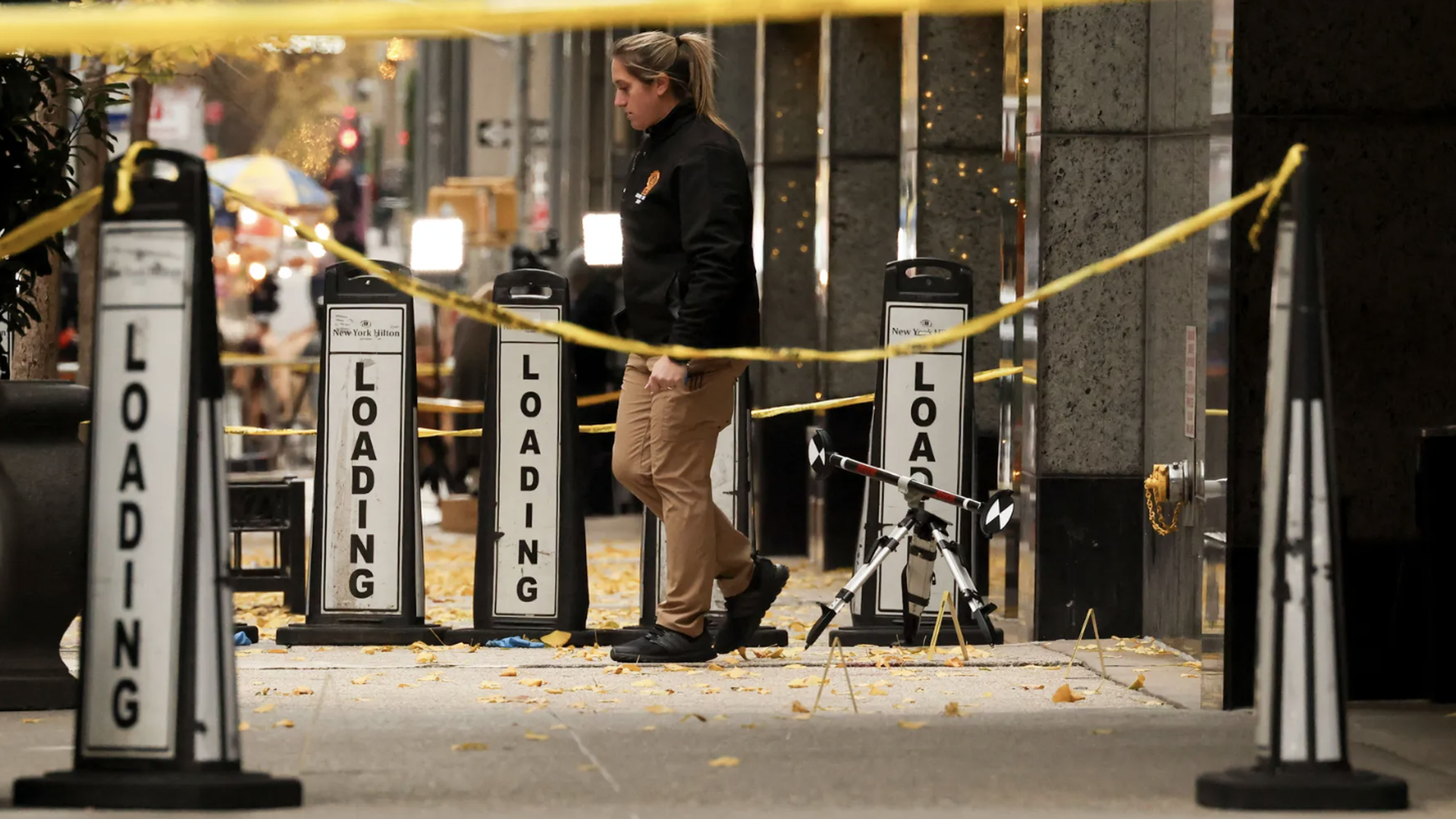 A law enforcement officer near police tape outside the New York Hilton Midtown in New York, US, on Wednesday, Dec. 4, 2024.