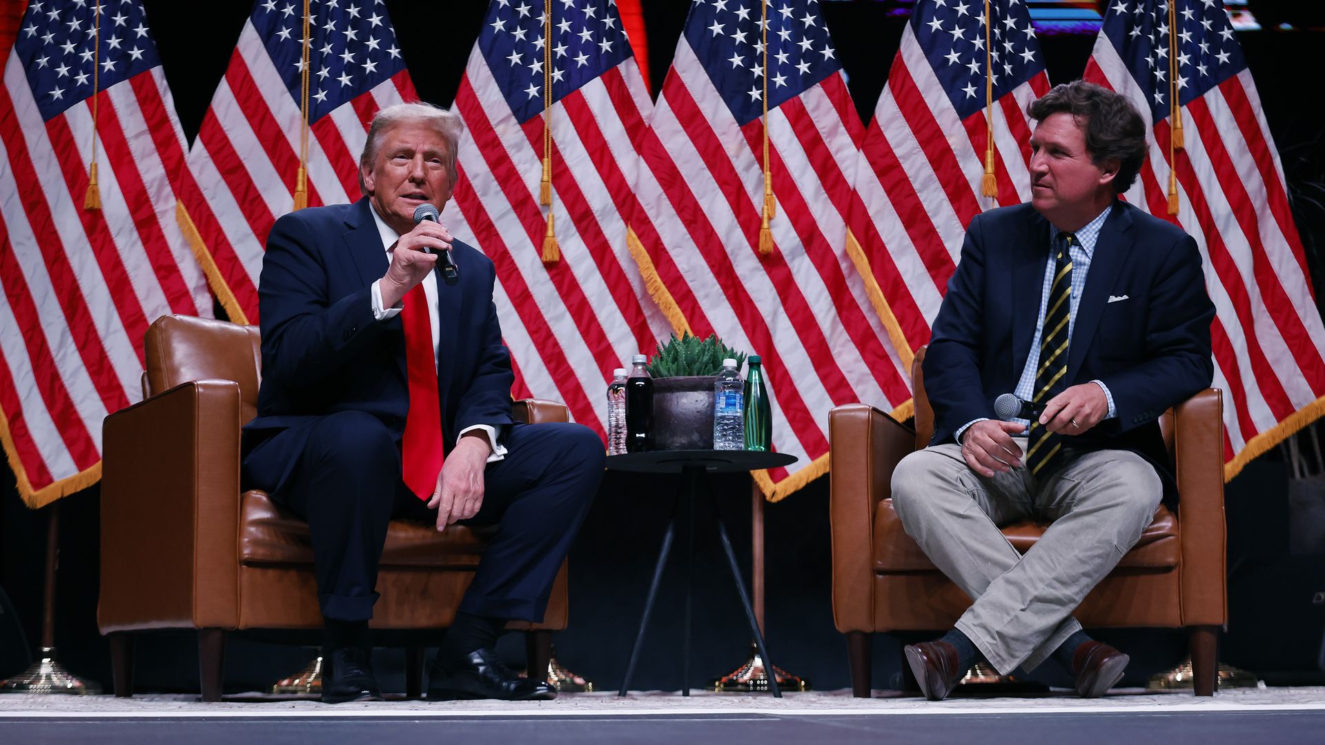 Donald Trump sits down for a conversation with Tucker Carlson during his Live Tour at the Desert Diamond Arena on October 31, 2024 in Phoenix, Arizona