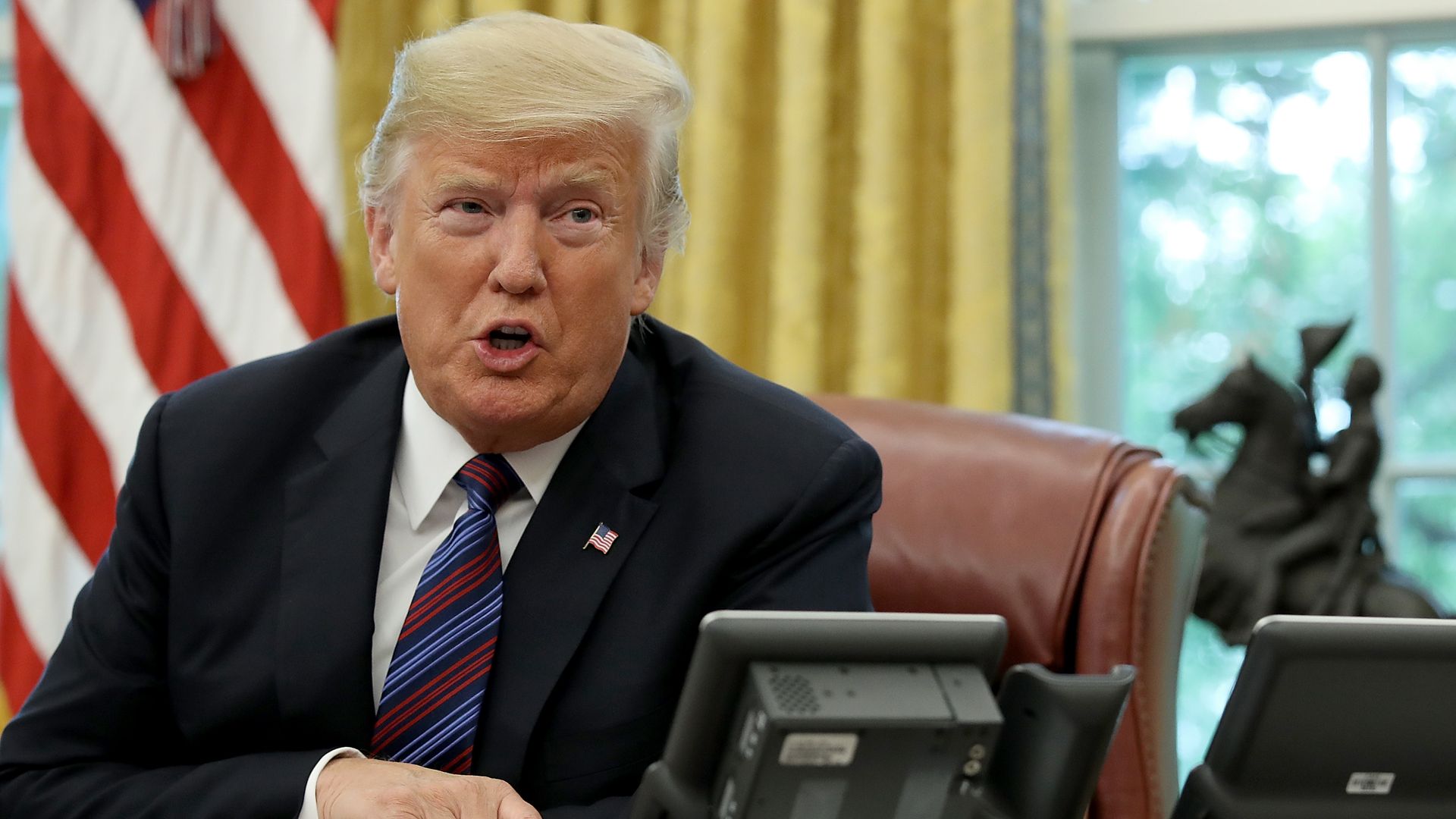 Donald Trump talking into a speakerphone