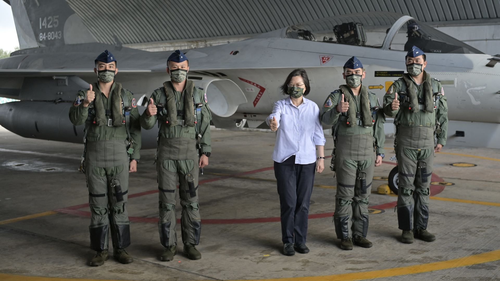 Taiwan President Tsai Ing-wen (C) with air force pilots  at an air force base while inspecting military troops on Penghu islands on August 30.
