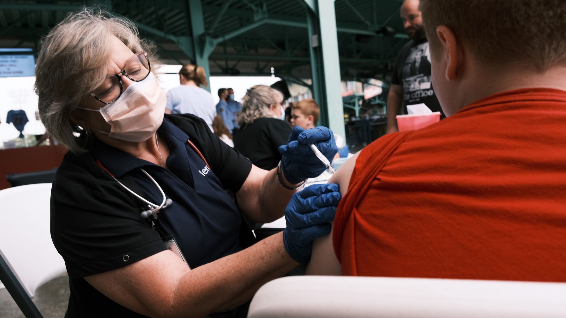 Picture of a nurse administering the vaccine on a patient.