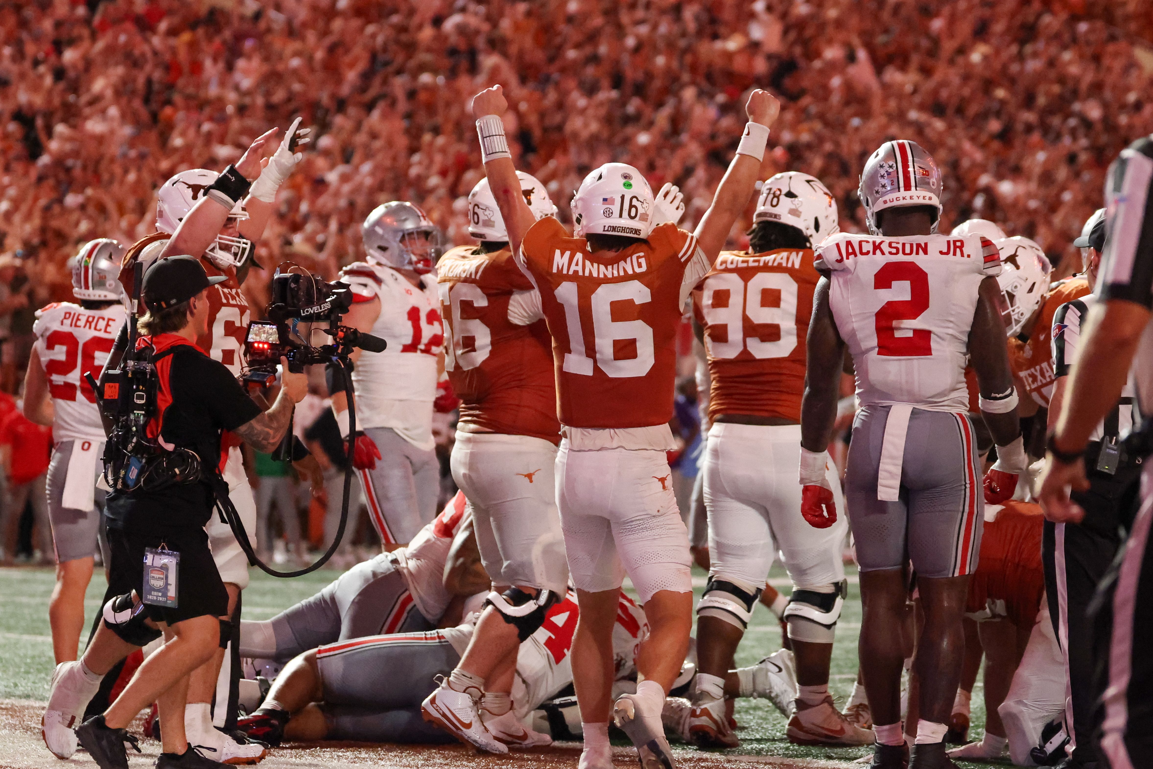 Texas players celebrating on the field after a play