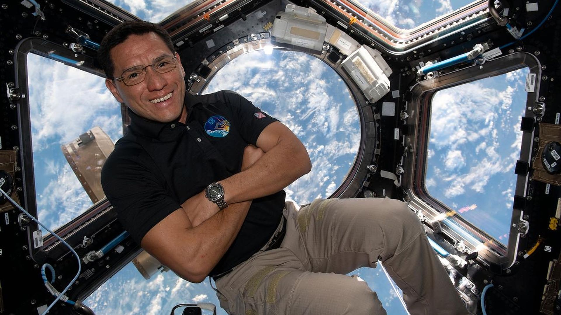 NASA Astronaut Frank Rubio smiles in a space shuttle in space.