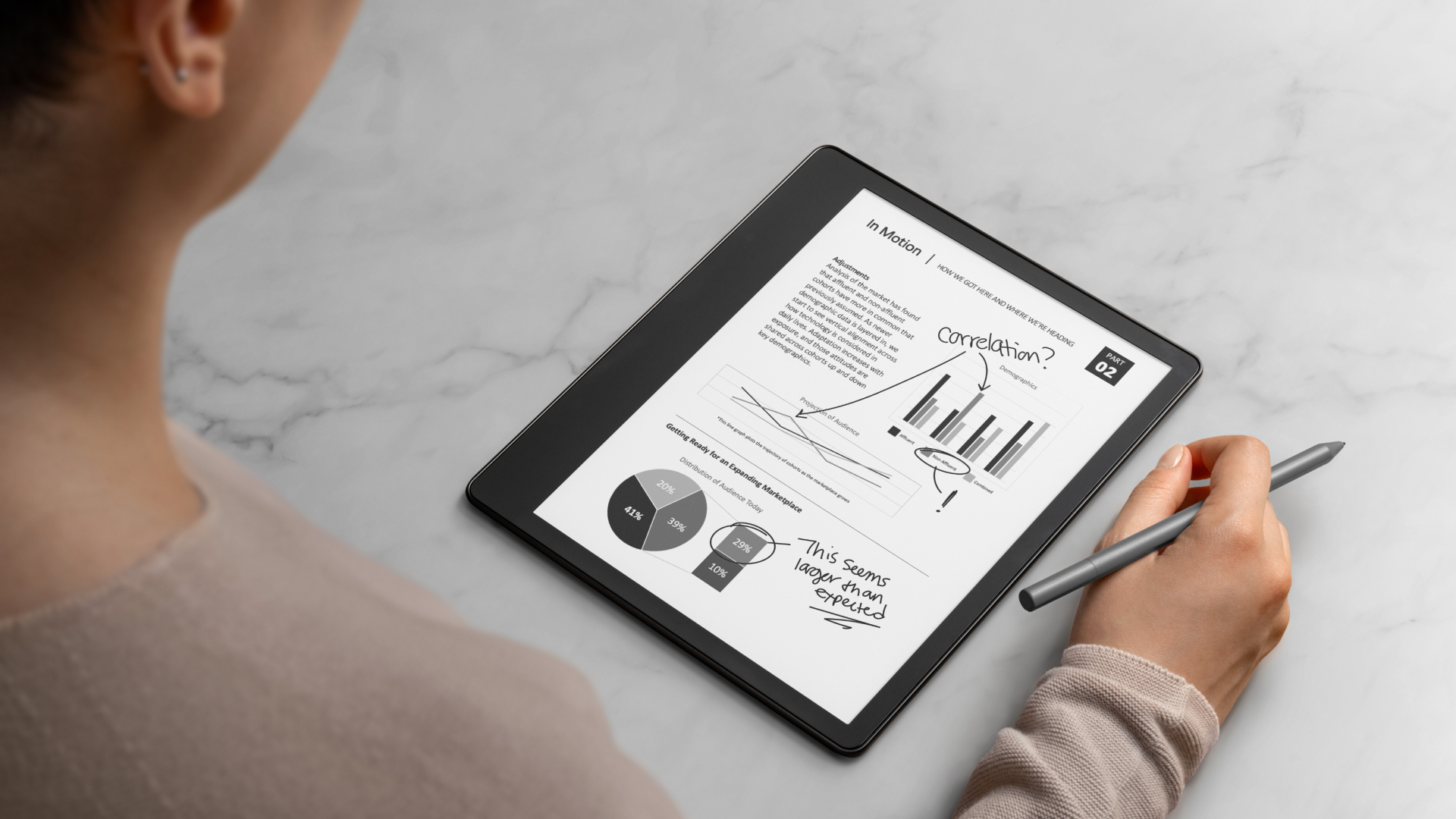 An image of a man using a Kindle Scribe to mark up a PDF document