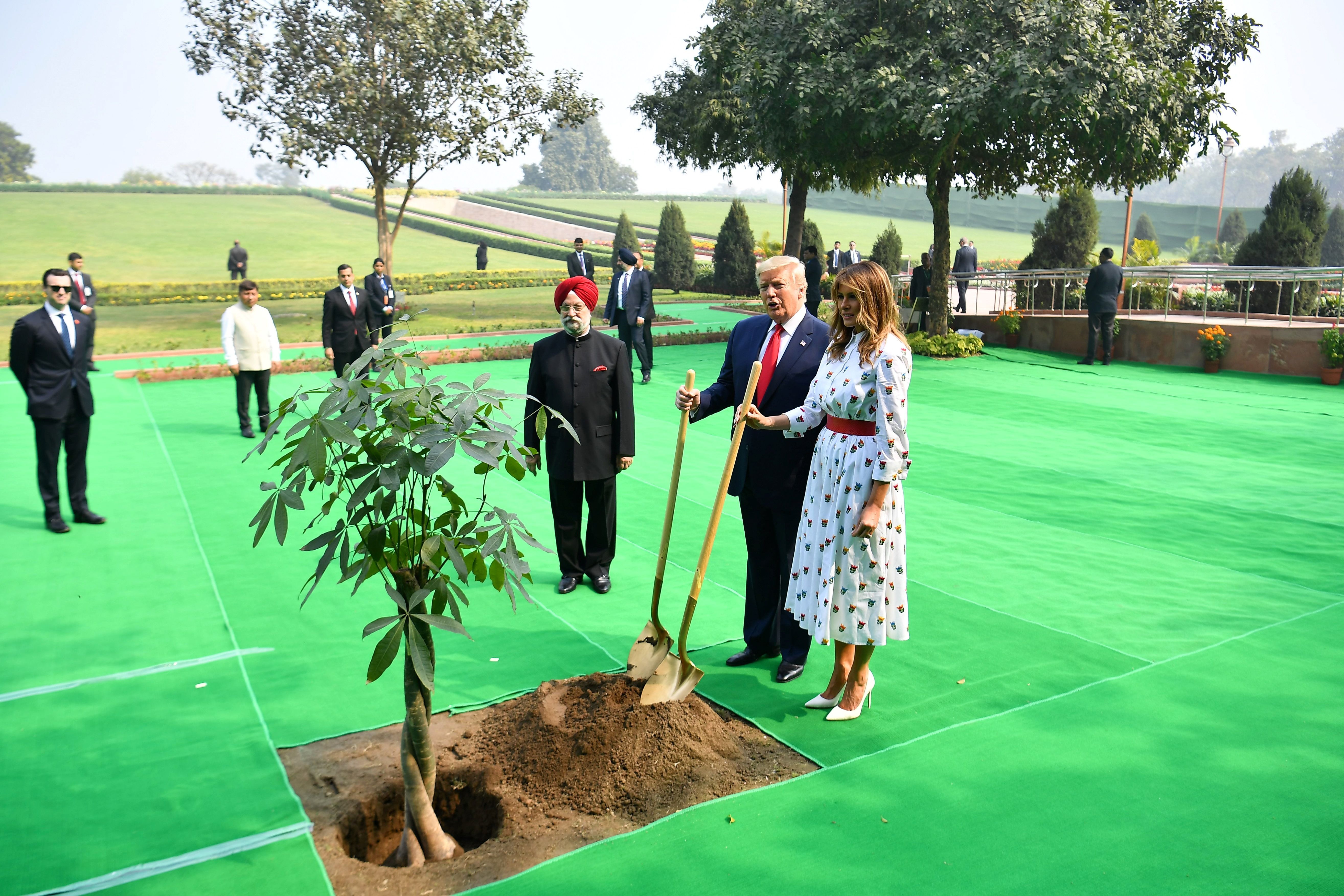  US President Donald Trump and First Lady Melania Trump plant a tree as they pay tribute at Raj Ghat, the memorial for Indian independence icon Mahatma Gandhi, in New Delhi on February 25