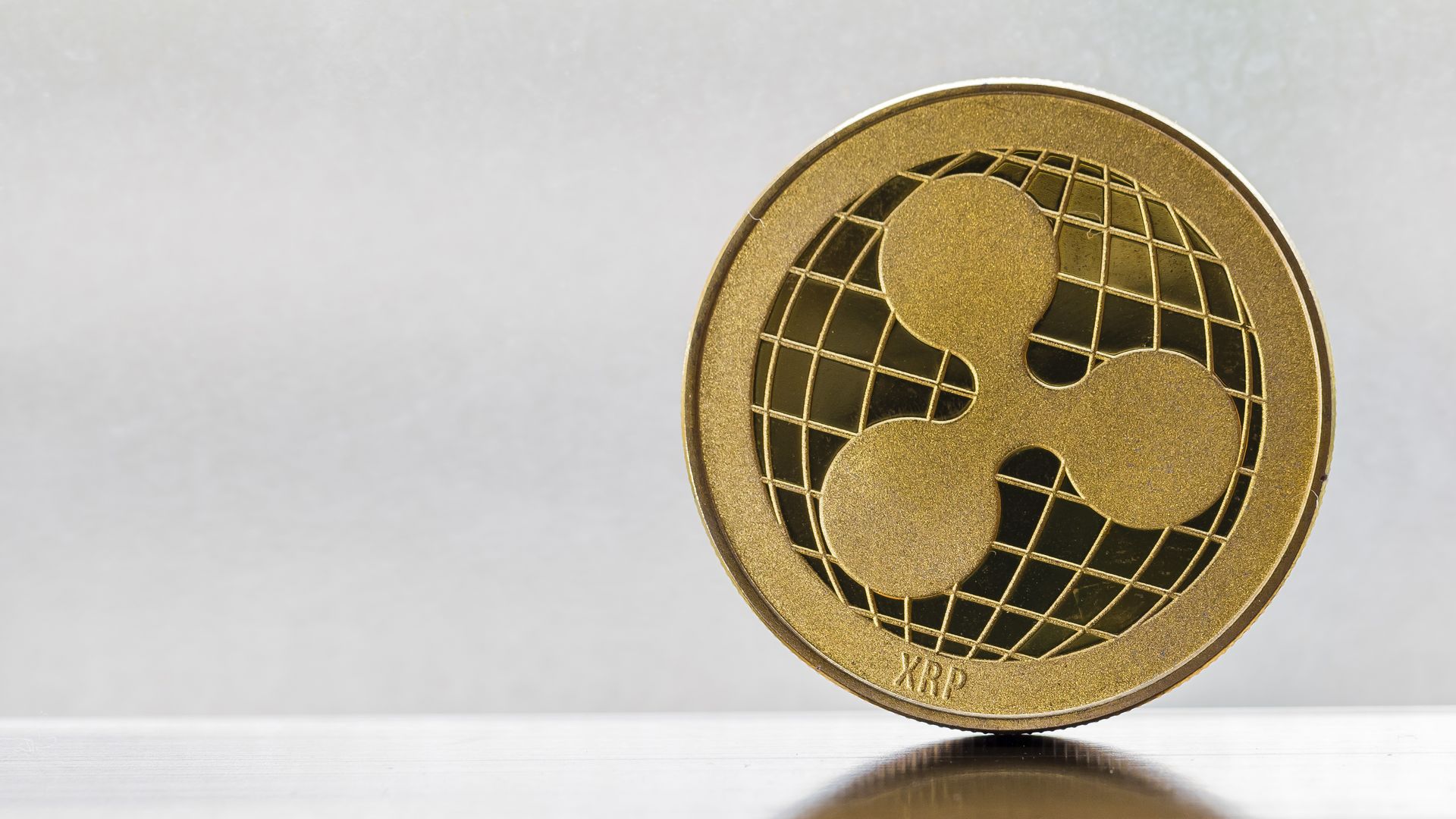 Coin with Ripple's XRP digital currency logo.